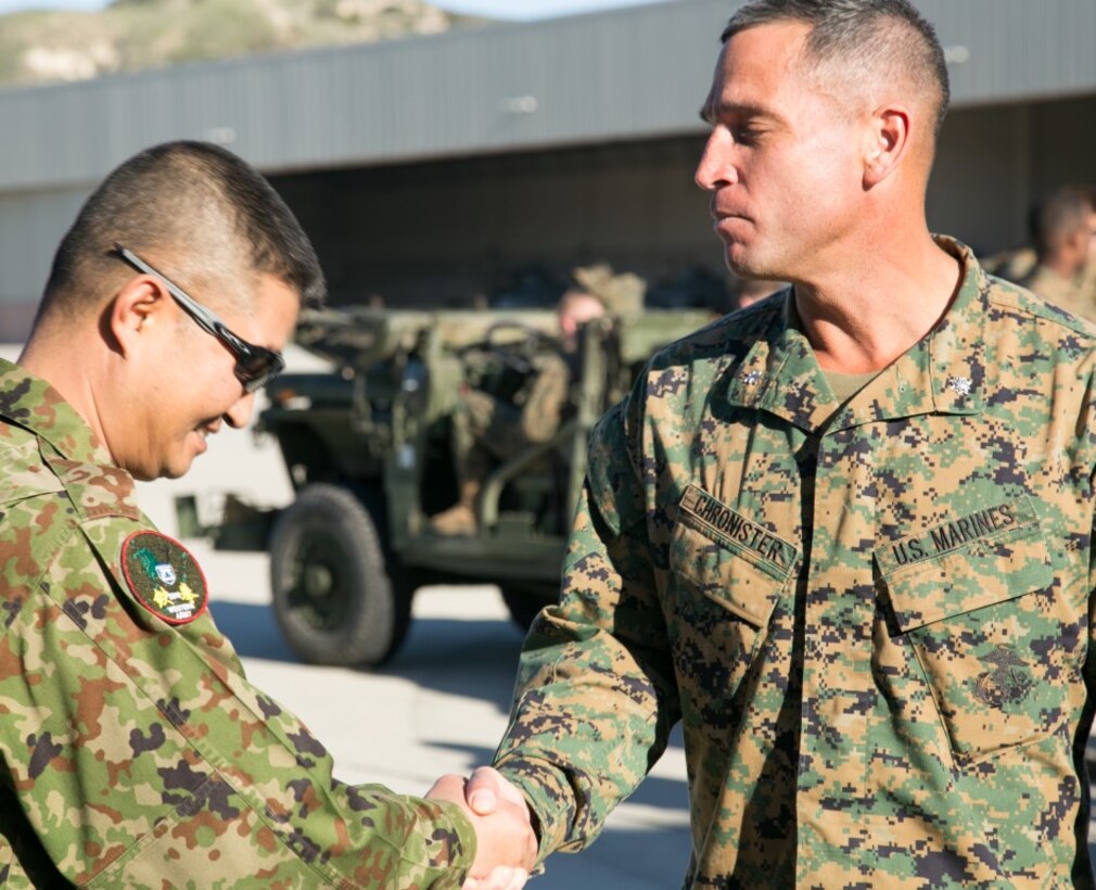 Japan Ground Self-Defense Force (JGSDF) Col. Yoshiyuki Goto, Western Army Infantry Regimental Commander, shakes hands with U.S. Marine Lt. Col. William Chronister, 1st Battalion, 11th Marines Commander, during Exercise Iron Fist 2016 aboard Marine Corps Base Camp Pendleton, Calif., Jan. 26, 2016. This training evolution is the largest bilateral exercise conducted by I Marine Expeditionary Force, and is just one of many examples of the Japan-U.S. Security Treaty at work. (U.S. Marine Corps photo by Lance Cpl. Brandon Maldonado/ Released)