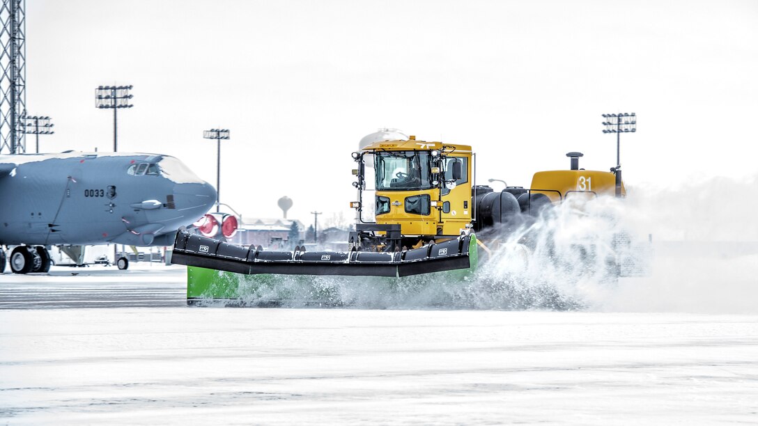 The 5th Civil Engineer Squadron removes snow from the flightline before a training sortie at Minot Air Force Base, N.D., Jan. 14, 2016. Bomber Airmen work around the clock in all weather conditions in order to provide B-52H Stratofortress firepower on demand. (U.S. Air Force photo/Airman 1st Class J.T. Armstrong)