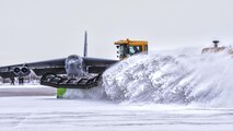 The 5th Civil Engineer Squadron removes snow from the flightline before a training sortie at Minot Air Force Base, N.D., Jan. 14, 2016. Bomber Airmen work around the clock in all weather conditions in order to provide B-52H Stratofortress firepower on demand. (U.S. Air Force photo/Airman 1st Class J.T. Armstrong)