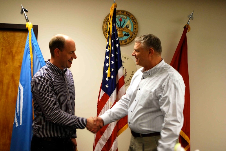 IWR’s Mr. Joe Manous (right) handing over the Institute for Water Resources coin to Mr. Hijdra (left) at the conclusion of his visit. The coin (not visible) is traditionally transferred through a firm handshake.