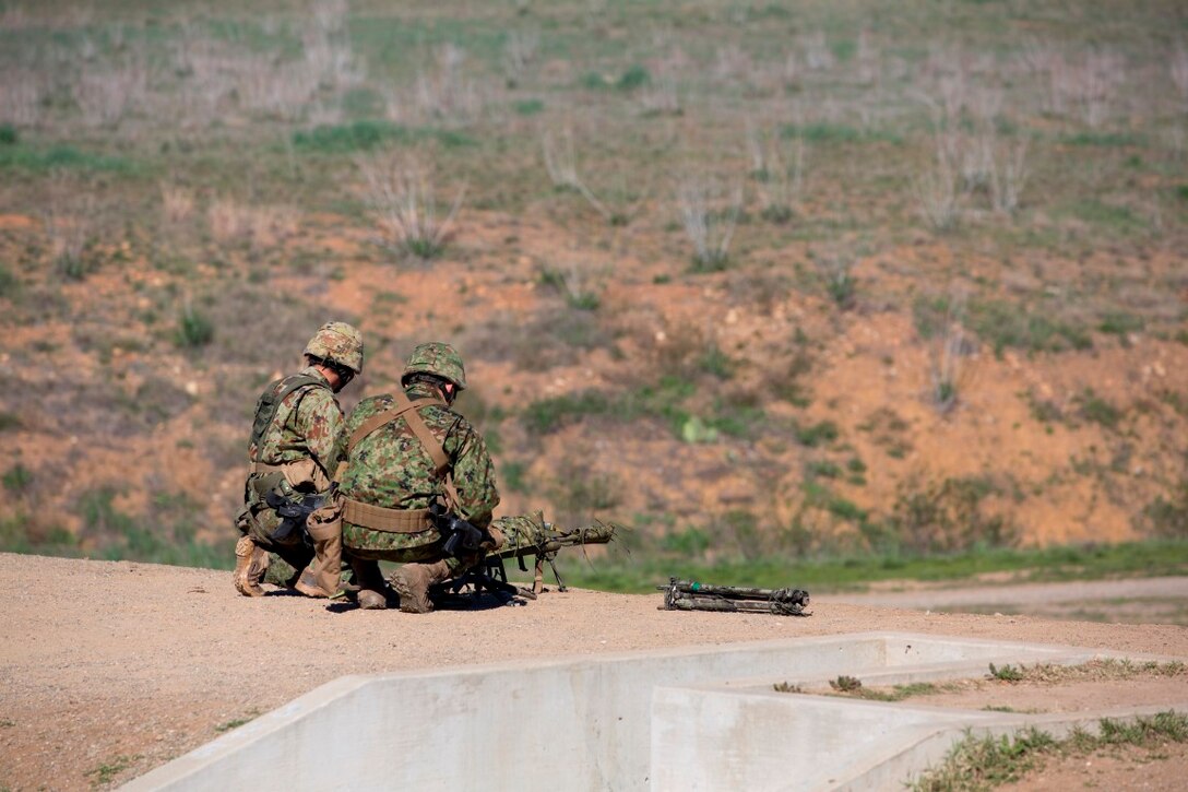 Japan Ground Self-Defense Force soldiers adjust their equipment between courses of fire during an unknown distance firing-range, aboard Marine Corps Base Camp Pendleton, Calif., Jan. 26, 2016. Over the next several weeks JGSDF soldiers will be working with their U.S. Marine counterparts during Exercise Iron Fist, an annual bilateral training exercise that enables Japanese soldiers to train with Marines on American soil, to improve the planning, communicating, and conducting of combined amphibious operations.