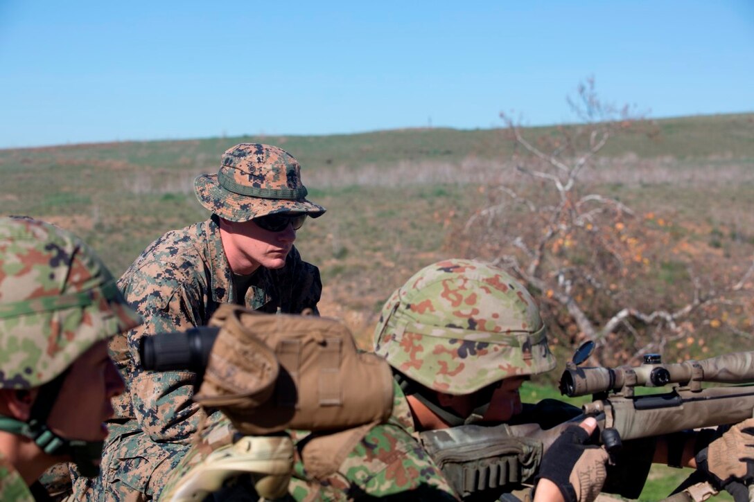 U.S. Marine Sgt. Mason Wilhelmy, primary marksmanship instructor with the Pre-Scout Sniper Course, 1st Marine Division Schools, observes the shooting form of a Japan Self-Defense Force soldier, during an unknown distance course of fire, aboard Marine Corps Base Camp Pendleton, Calif., Jan. 28, 2016. This training was a part of Exercise Iron Fist, an annual bilateral amphibious training exercise held in Southern California between the U.S. Marine Corps and the JGSDF.