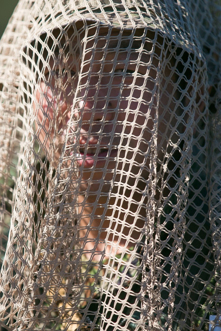 A soldier with the Japan Ground Self-Defense Force (JGSDF) dons a veil during hide site construction training during Exercise Iron Fist aboard Camp Pendleton, Calif., Jan. 28, 2016.  Veils aid with camouflaging troops, blending them into surrounding areas by refracting light. (U.S. Marine Corps photo by Cpl. Xzavior T. McNeal/Released)