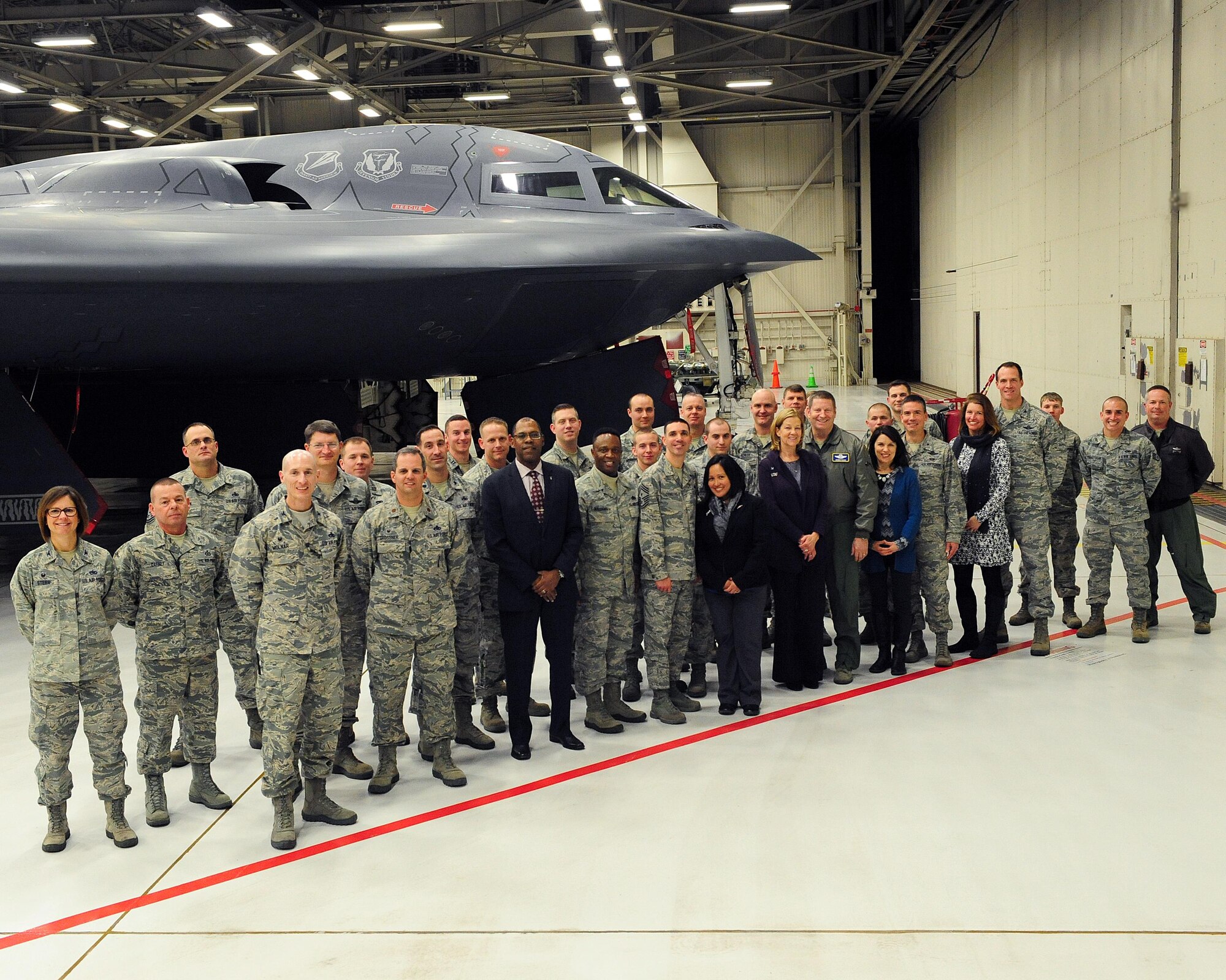 Members of Team Whiteman stand with Gen. Robin Rand, Air Force Global Strike Command commander, his wife, Kim, and AFGSC Command Chief Master Sergeant Calvin Williams next to a B-2 Spirit at Whiteman Air Force Base, Mo., Jan. 19, 2016. While touring the aircraft, AFGSC leadership met with Airmen to hear about weapon systems available to the world’s premier stealth bomber. (U.S. Air Force photo illustration by Airman 1st Class Jazmin Smith) 