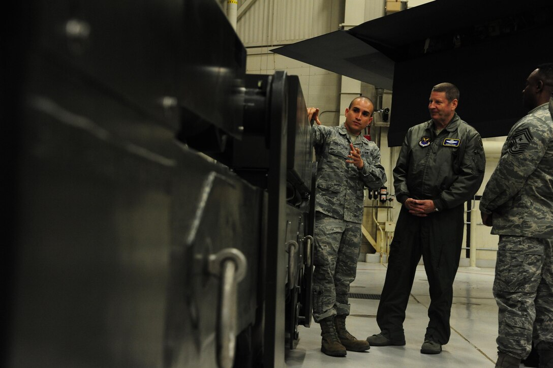 Staff Sgt. Ishmael Otero Octtaviani, a 509th Munitions Squadron munitions trainer, explains the MHU-204 trailer capabilities to Gen. Robin Rand, AFGSC commander, at Whiteman Air Force Base, Mo., Jan. 19, 2016. Rand visited different facilities and learned about their missions as well as future base innovations. (U.S. Air Force photo by Senior Airman Keenan Berry/Released)