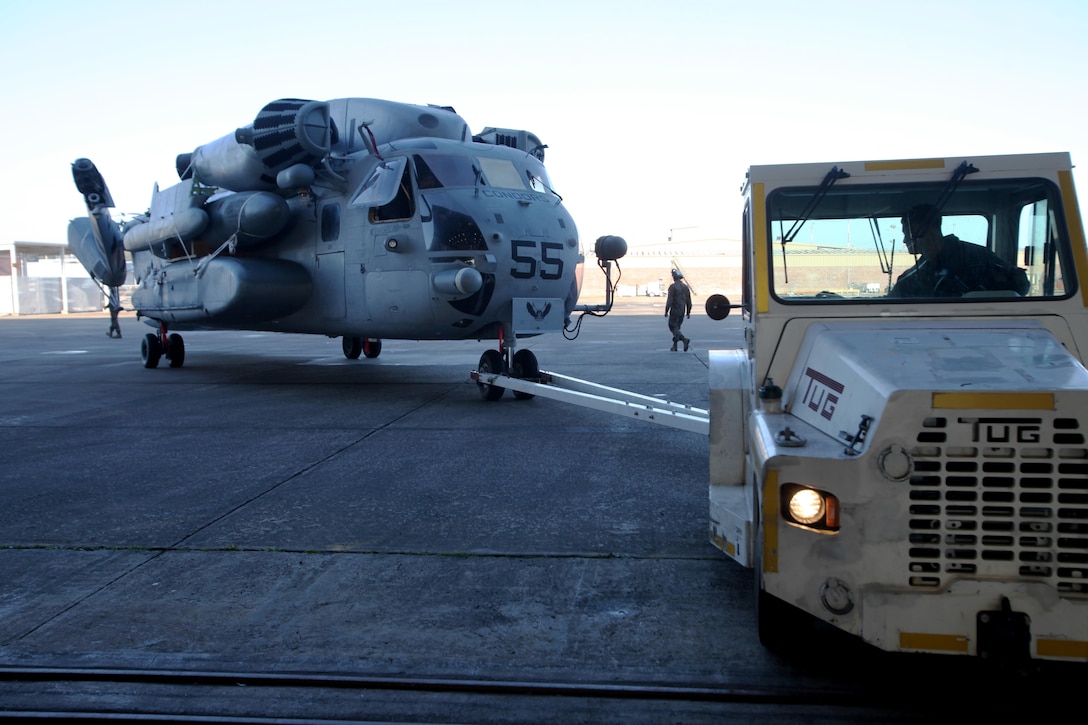 Cpl. Conner Tucker tows a CH-53E Super Stallion during aircraft transportation at Marine Corps Air Station Cherry Point, N.C., Jan. 29, 2016. 63 Marines from Marine Heavy Helicopter Squadron 464 broke down CH-53E Super Stallions and AH-1W Super Cobras for transport to Norway for Exercise Cold Response 2016. Tucker is a flight line mechanic with HMH-464. (U.S. Marine Corps photo by Cpl. Jason Jimenez/Released)