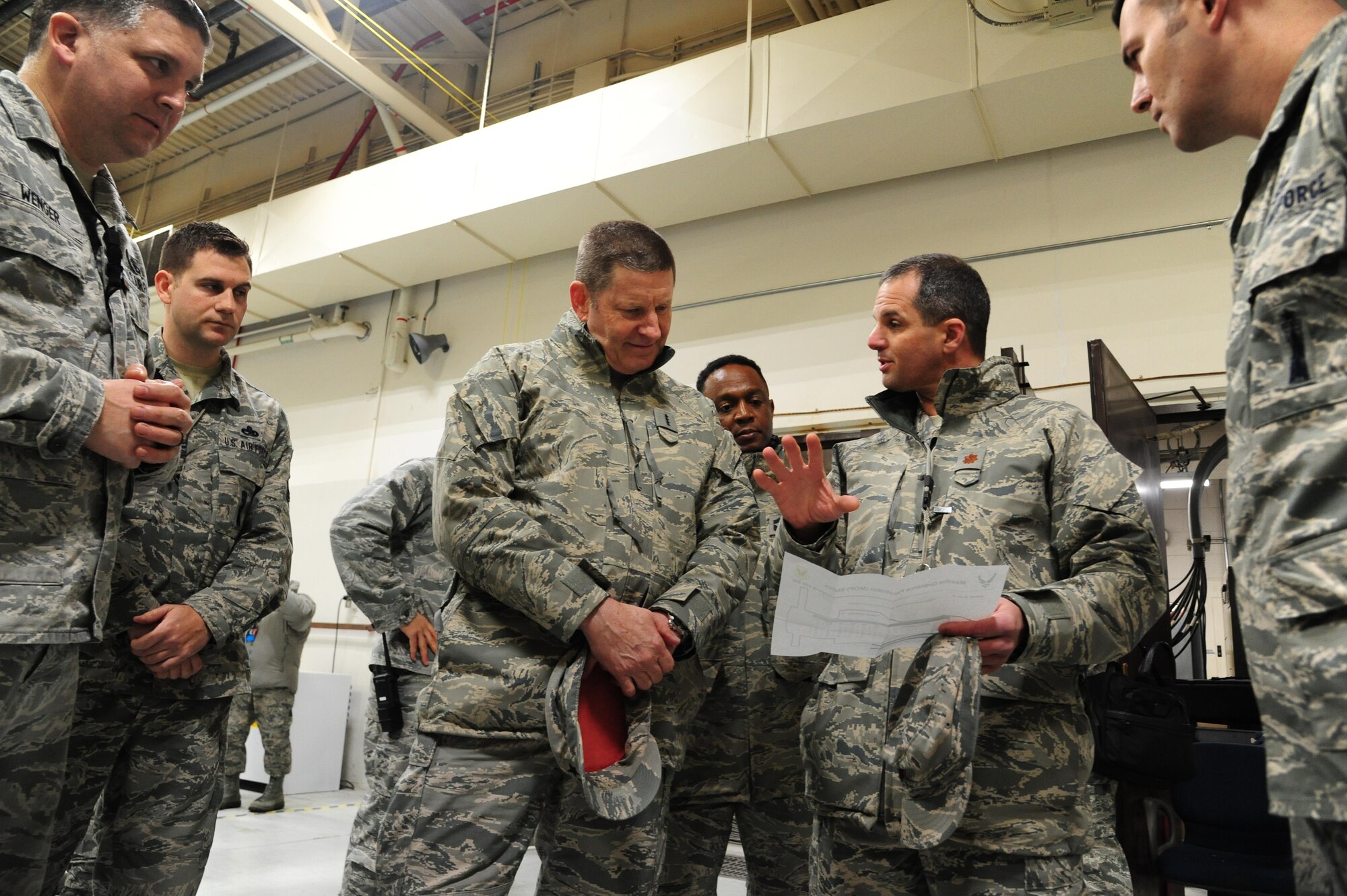 Maj. Matthew Drossner, the 509th Munitions Squadron commander, center right, talks about the massive ordnance penetrator with Gen. Robin Rand, AFGSC commander, center-left, at Whiteman Air Force Base, Mo., Jan. 20, 2016. (U.S. Air Force photo by Senior Airman Keenan Berry)