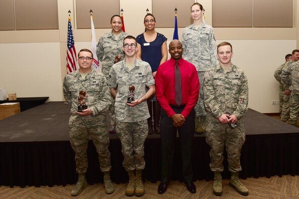 Staff Sgt. Tiffany Hartman and Senior Airman Jonathan Rothe, both from the Air Reserve Personnel Center, stand with Team Buckley quarterly award winners Jan. 28, 2016, at the Leadership Development Center on Buckley Air Force Base, Colo. The award winners were chosen because of their hard work and dedication in their work centers. (U.S. Air Force photo by Airman 1st Class Gabrielle Spradling)