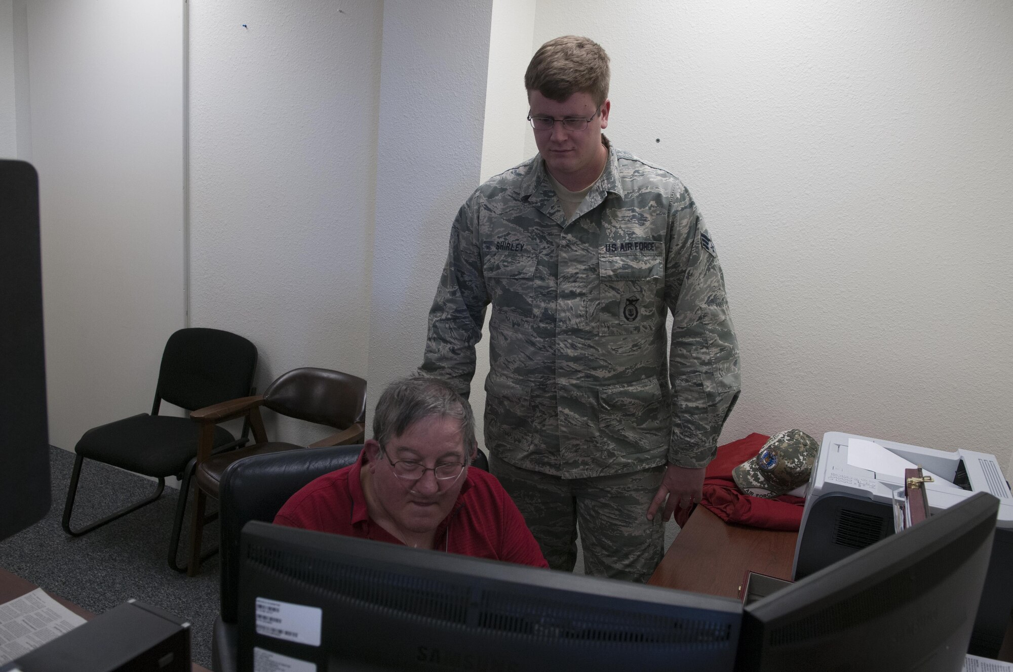 Retired Master Sgt. Basil Heise, 90th Missile Wing Tax Center volunteer, helped Senior Airman Lance Shirley, 790th Missile Security Forces Squadron, compete his taxes for the season. The center is available for appointments and has more than a dozen volunteers available for tax assistance. (U.S. Air Force photo by Airman 1st Class Malcolm Mayfield)