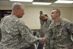 Gen. Frank Grass, National Guard Bureau chief, shakes the hand of Chief Warrant Officer 2 Carlos Castillo from Bravo Company, 1st Battalion, 126th Aviation Regiment. The general visited aviation troops at Redding Municipal Airport in Northern California on Aug. 19, 2015. Grass, reacting to a report by the National Commission on the Future of the Army, said he appreciated the panel's recommendations.