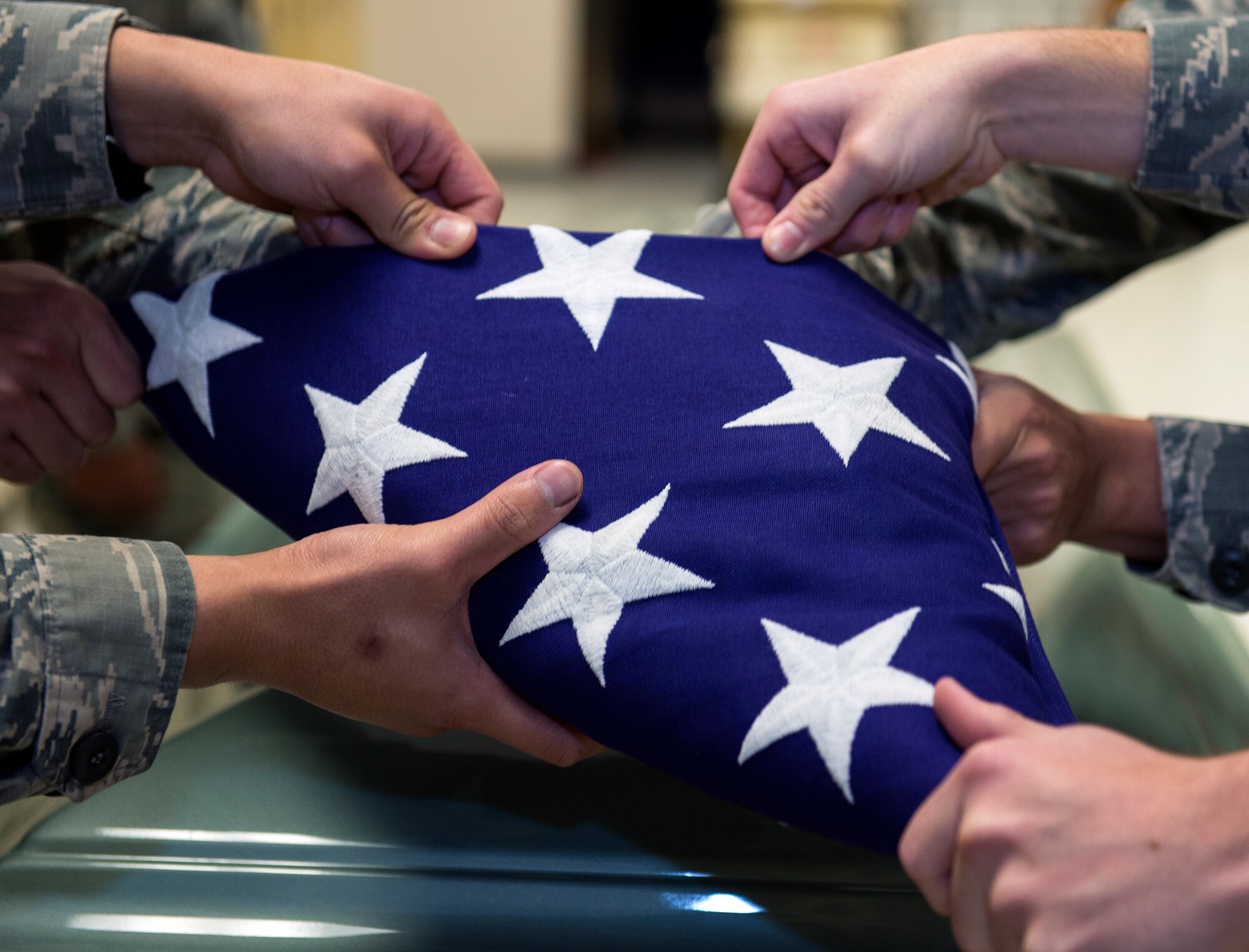Members of the Moody Base Honor Guard fold an American flag during training, Jan. 28, 2016, at Moody Air Force Base, Ga.  These honor guardsmen are responsible for providing military funeral honors and ceremonial support throughout South Georgia and North Florida. (U.S. Air Force photo by Airman 1st Class Greg Nash/Released) 