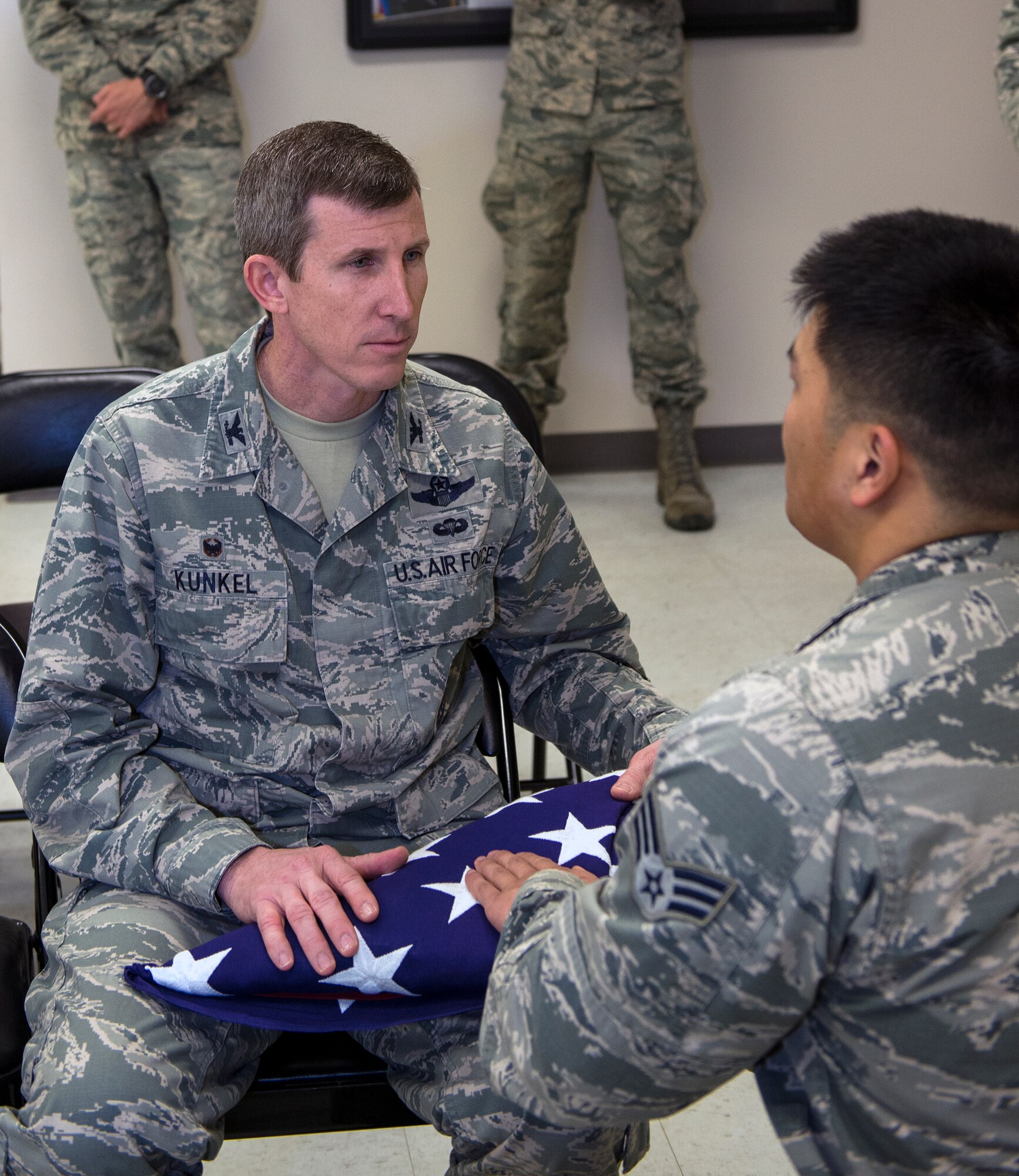 U.S. Air Force Col. Thomas Kunkel, 23d Wing commander, receives an American flag from Senior Airman Hyeukju Kwon, Moody Honor Guardsman, during training, Jan. 28, 2016, at Moody Air Force Base, Ga. Kwon gave a message of condolence to Kunkel, who acted as the next-of-kin during a mock funeral. (U.S. Air Force photo by Airman 1st Class Greg Nash/Released) 
