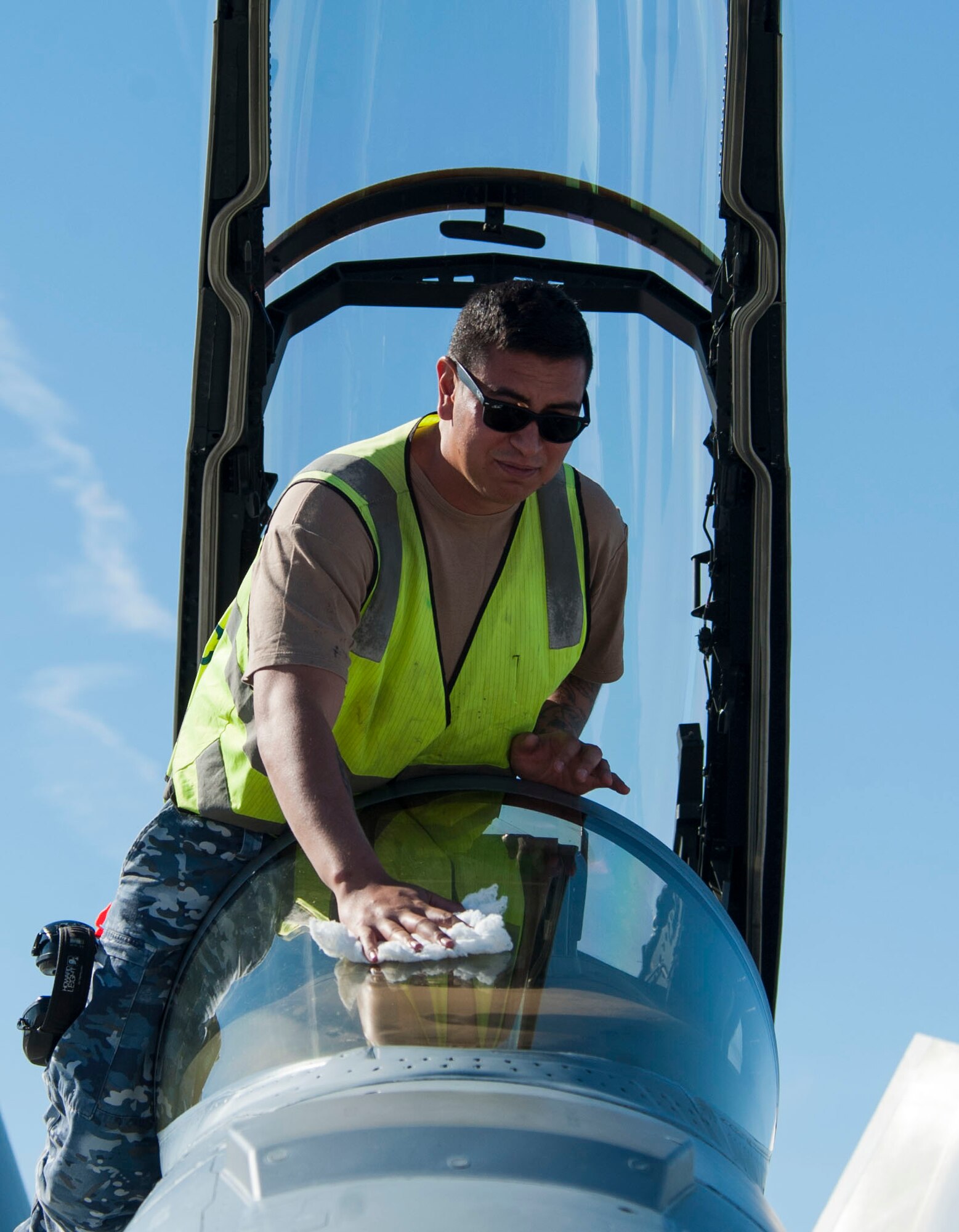 Royal Australian Air Force Leading Aircraftman Isagani Barry, polishes the canopy of an F/A-18 Super Hornet belonging to 1 Squadron, RAAF Amberley, Australia, during Red Flag 16-1 at Nellis Air Force Base, Nev., Jan 26, 2016. Aircraft maintainers work tirelessly to ensure that the aircraft they are responsible for are in prime condition for the aircrew to use when it comes time to train and fight. (U.S. Air Force photo by Senior Airman Thomas Spangler)