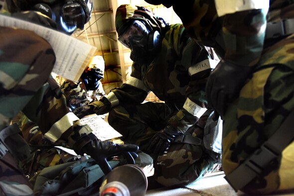 Airmen from the 4th Fighter Wing complete an unexploded ordnance identification test during an ability to survive and operate rodeo Jan. 29, 2016, at Seymour Johnson Air Force Base, North Carolina. As part of exercise Coronet Warrior 16-01, Airmen of various ranks and job specialties completed a five station event to demonstrate survival and operations capabilities in a chemical environment. (U.S. Air Force photo/Staff Sgt. Chuck Broadway)
