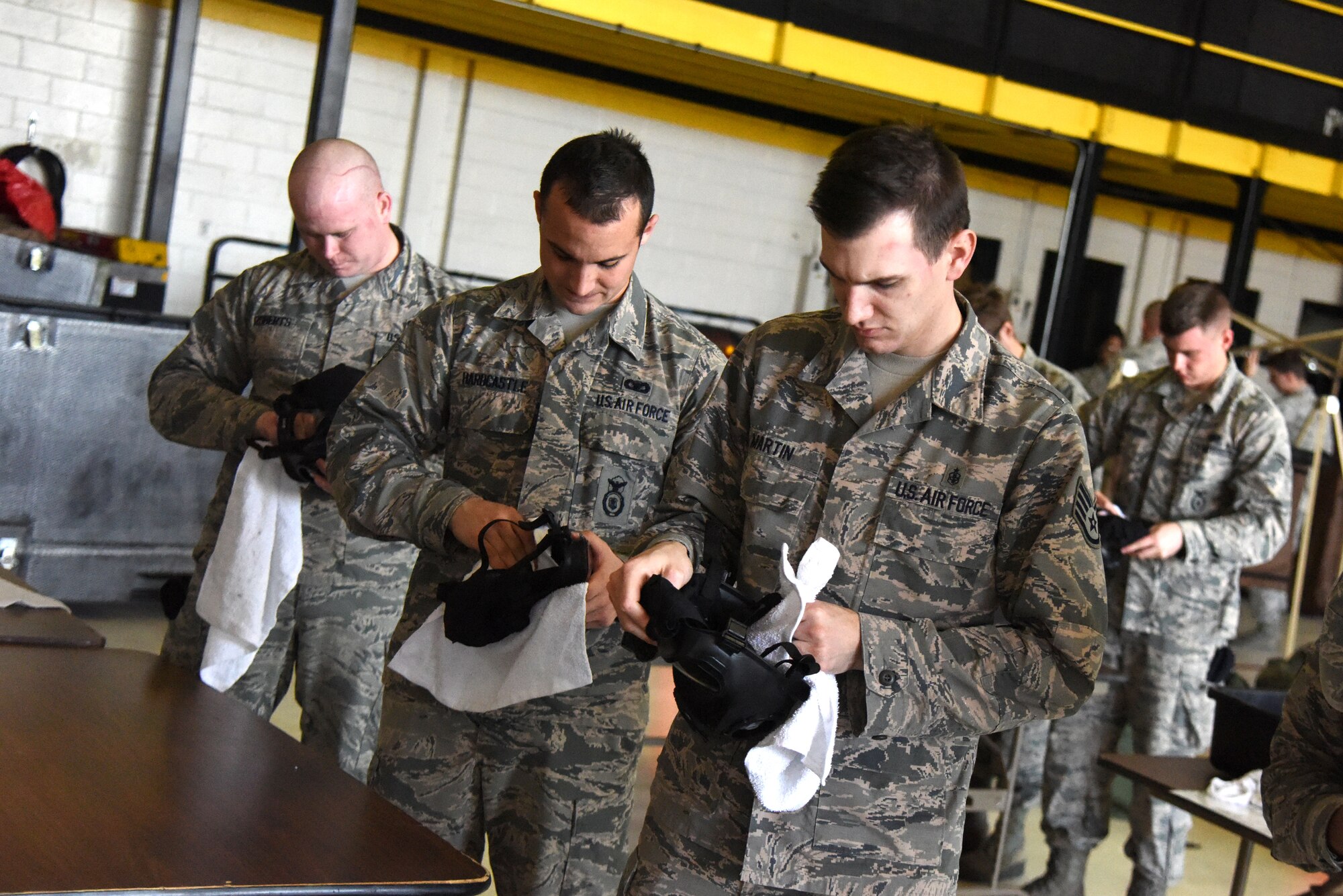 Airmen from the 4th Fighter Wing clean gas masks following completion of an ability to survive and operate rodeo Jan. 29, 2016, at Seymour Johnson Air Force Base, North Carolina. The rodeo kicked off Coronet Warrior 16-01, a readiness exercise conducted to test the base's capabilities and operations in a chemical environment. (U.S. Air Force photo/Staff Sgt. Chuck Broadway)