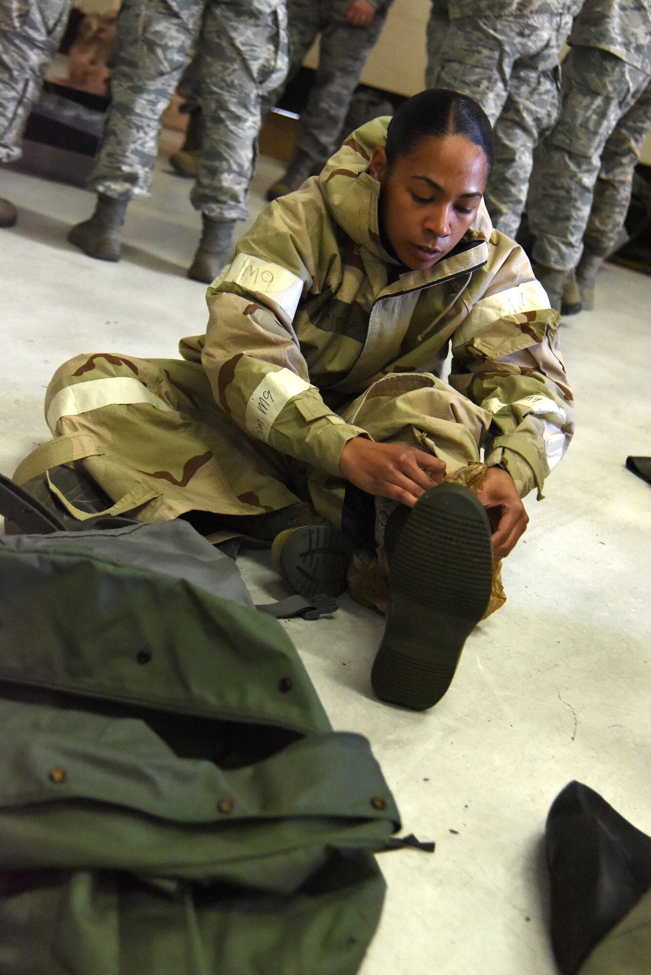 Senior Airman Jasmine Bailey, 4th Medical Operations Squadron mental health technician, dons mission oriented protective posture gear Jan. 29, 2016, during an ability to survive and operate rodeo at Seymour Johnson Air Force Base, North Carolina. During exercise Coronet Warrior 16-01, Airmen completed ATSO tests at multiple stations to demonstrate operations capabilities while in a chemical environment. (U.S. Air Force photo/Staff Sgt. Chuck Broadway)