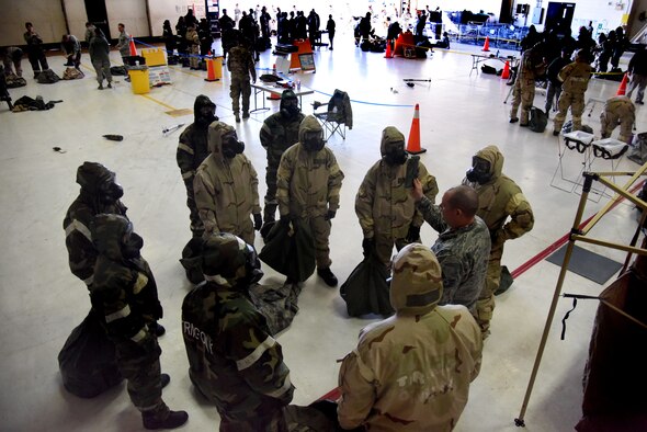 Tech. Sgt. Adam Giessman, 4th Civil Engineer Squadron emergency management noncommissioned officer in charge of plans and publications, instructs a group of airmen on proper decontamination procedures Jan. 29, 2016 at Seymour Johnson Air Force Base, N.C. More than 400 airmen processed through an "ability to survive and operate rodeo" to test their skills at donning and removing mission oriented protective posture, identifying unexploded ordnance and providing self-aid buddy care. (U.S. Air Force photo/Staff Sgt. Chuck Broadway) 