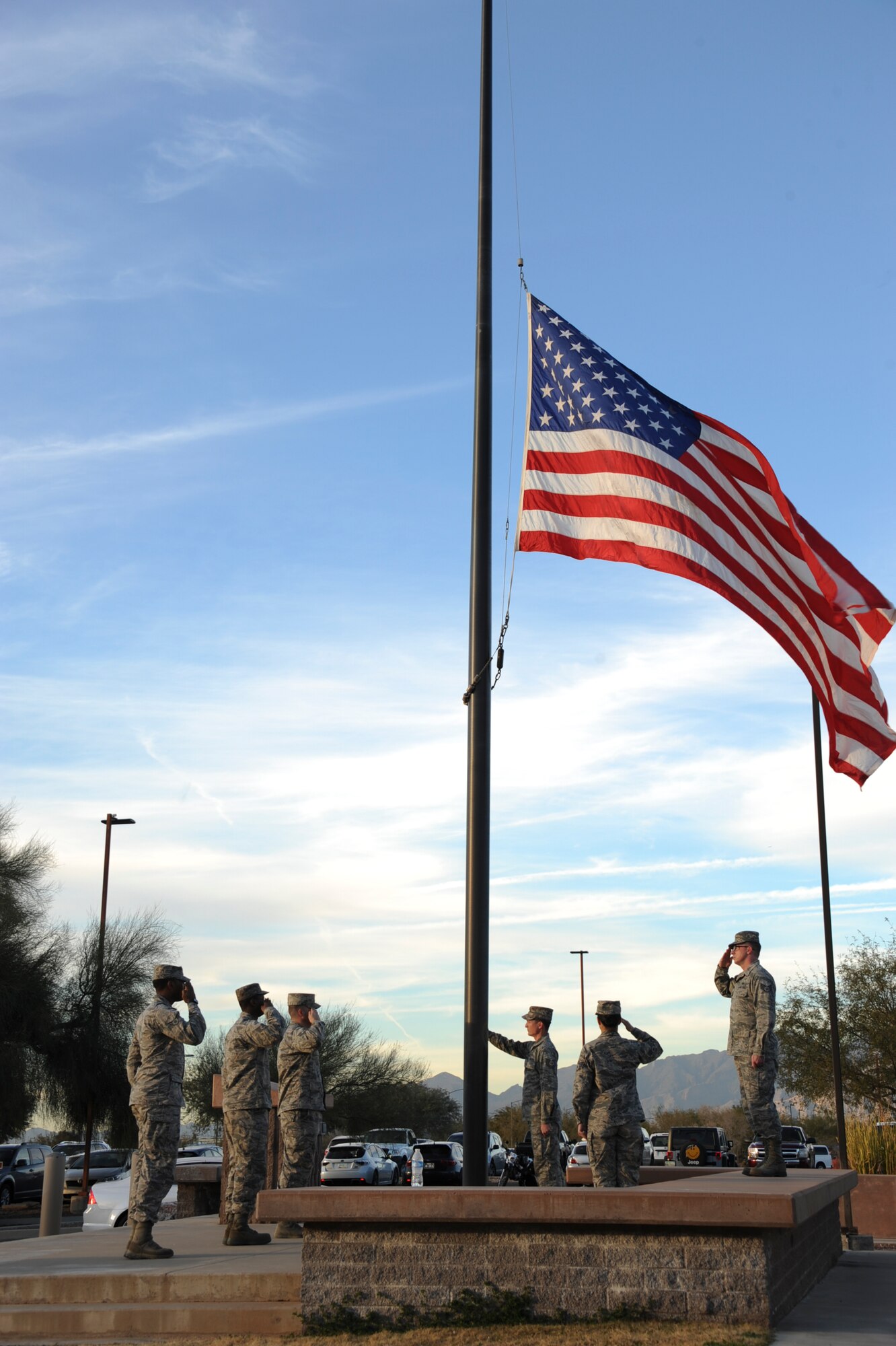 U.S. Airmen from the 355th Fighter Wing lower the American flag during a retreat ceremony at Davis-Monthan Air Force Base, Ariz., Jan. 28, 2016. The American flag flying outside the 355th Fighter Wing building was taken down ceremoniously and handed off to the McCulloch-Wagner American Legion Post 109 to be retired. (U.S. Air Force photo by Airman Basic Nathan H. Barbour/Released) (U.S. Air Force photo by Airman Basic Nathan H. Barbour/Released)