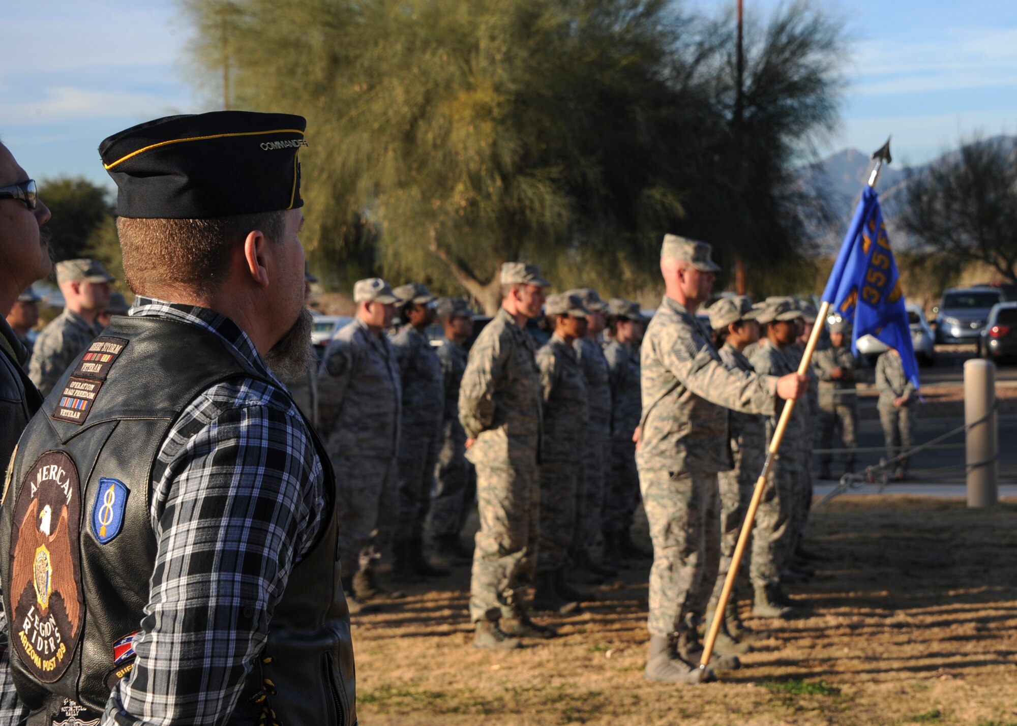 Veterans and a formation of U.S. Airmen from the 355th Fighter Wing prepare for a retreat ceremony at Davis-Monthan Air Force Base, Ariz., Jan. 28, 2016. The American flag outside the 355th Fighter Wing building was taken down ceremoniously and handed off to the McCulloch-Wagner American Legion post 109 to be retired. (U.S. Air Force photo by Airman Basic Nathan H. Barbour/Released)