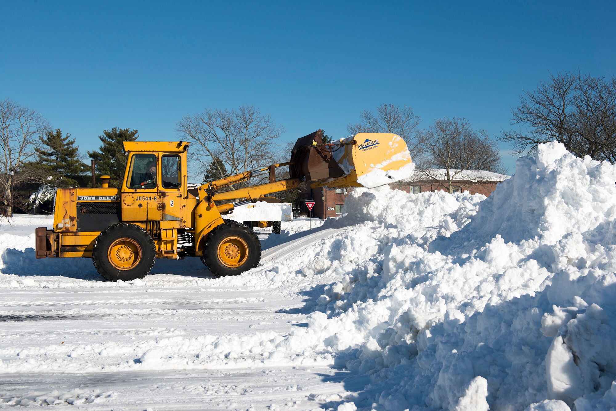 A front-end loader specially equipped for snow removal begins the road-clearing process on Joint Base McGuire-Dix-Lakehurst, N.J., Jan. 24. The blast of snow that covered much of the Northeast and Mid-Atlantic parts of the country was enough to shut down many government and non-government organization. (U.S. Air Force photo by Senior Airman Joshua King)