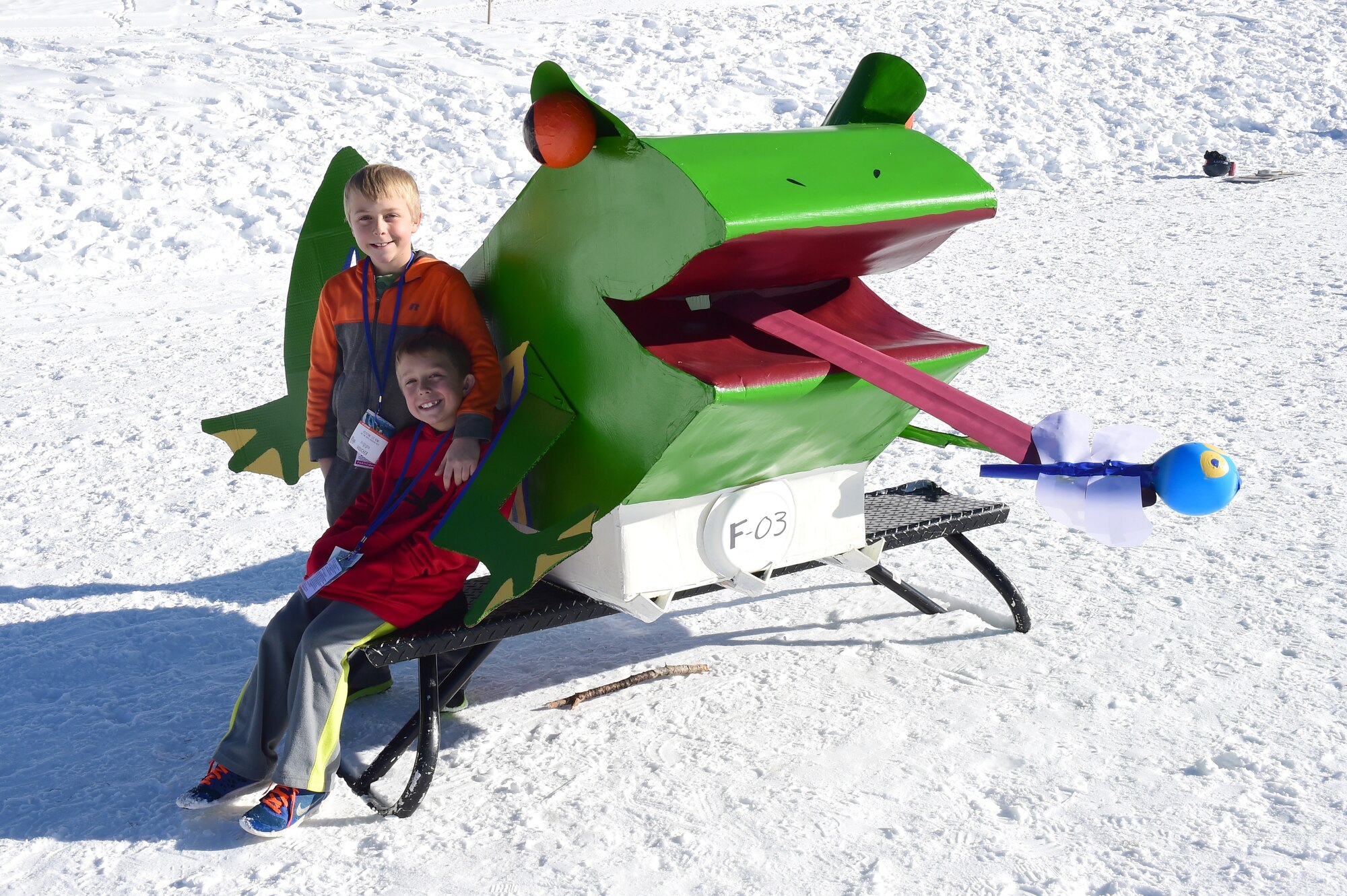 Landen and Casey Rup pose with their homemade cardboard sled before the Snofest cardboard derby Jan. 23, 2016, at Keystone Resort, Colo. Snofest is a military appreciation event at Keystone Resort for the Front Range Military Bases, that included a cardboard derby with nine categories including biggest crowd pleaser, fastest and most creative. (U.S. Air Force photo by Airman 1st Class Gabrielle Spradling/Released)