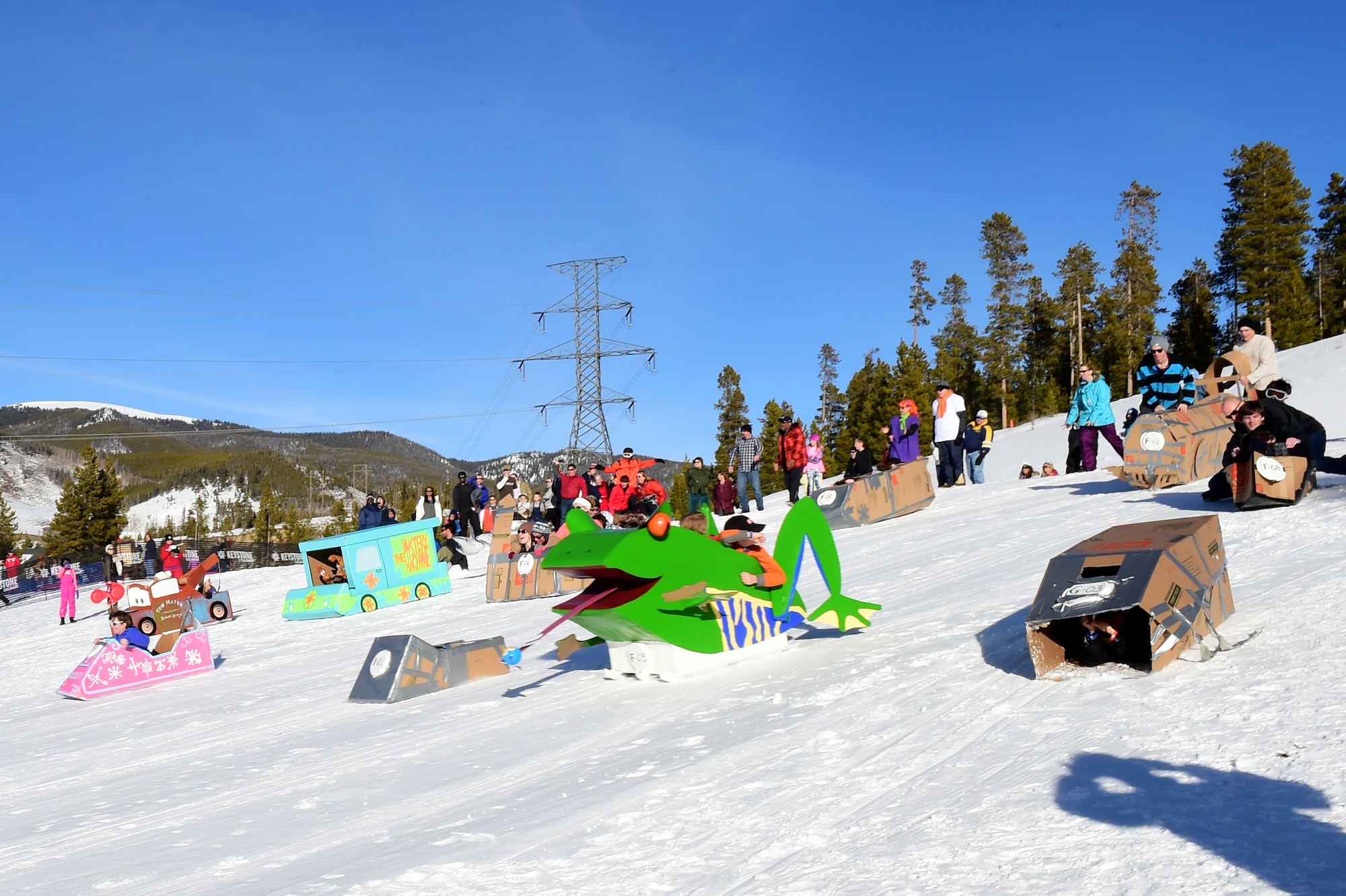 All of the participants of the Snofest cardboard derby take one last run down the hill during Snofest Jan. 23, 2016, at Keystone Resort, Colo. Snofest is a military appreciation event at Keystone Resort for the Front Range Military Bases, that included a cardboard derby with nine categories including biggest crowd pleaser, fastest and most creative. (U.S. Air Force photo by Airman 1st Class Gabrielle Spradling/Released)