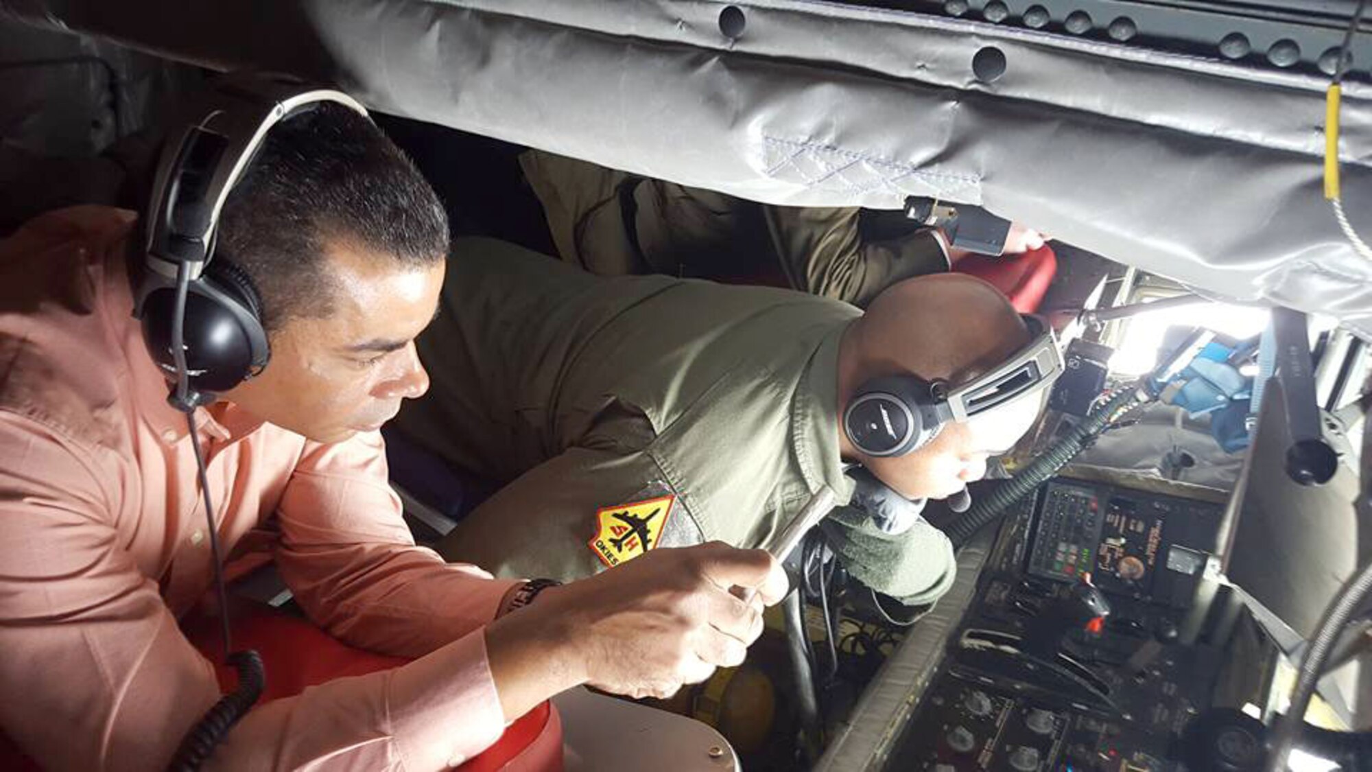 Legislative assistant Keith Roachford of New Jersey Sen. Robert Menendez’s office observes a aerial refueling between a KC-135R Stratotanker and an E-3 Sentry over the skies of Texas, Jan. 19, 2016.  The Congressional staff members toured Air Force Reserve Command facilities at Tinker then flew on a training mission to increase their understanding of the capabilities of the Air Force. (U.S. Air Force/Maj. Jon Quinlan)

