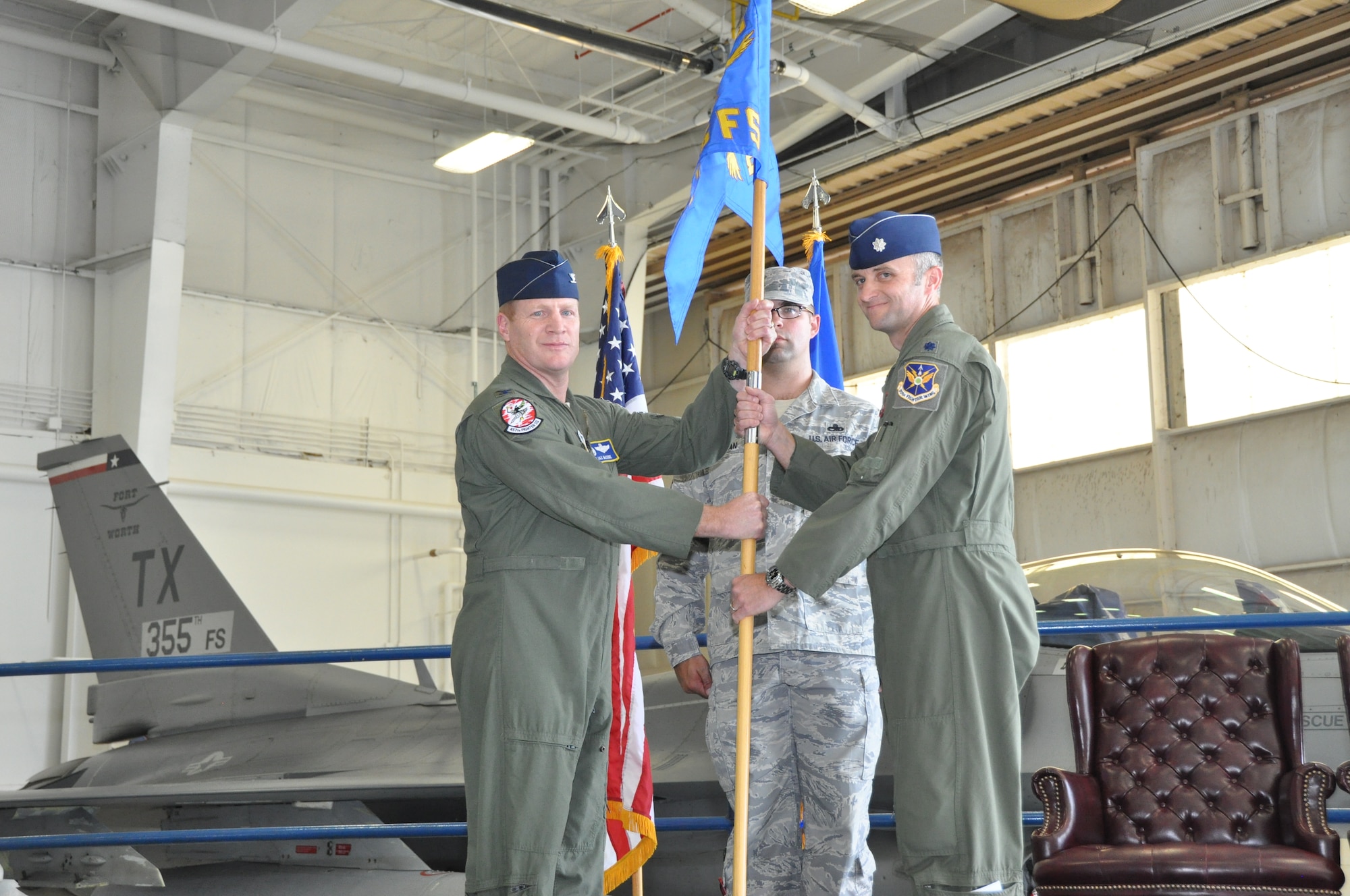 NAVAL AIR STATION FORT WORTH JOINT RESERVE BASE, Texas – Col. James McCune (left), 495th Fighter Group commander, presents the 355th Fighter Squadron guidon Oct. 5 to Lt. Col. Jeffrey Cunningham (right), 355 FS commander, during the re-designation ceremony here. The 355 FS, who fly the F-16 Fighting Falcon alongside the 301st Fighter Wing, is the first active associate fighter squadron within the Air Force Reserve. (U.S. Air Force photo by Ms. Julie Briden-Garcia)