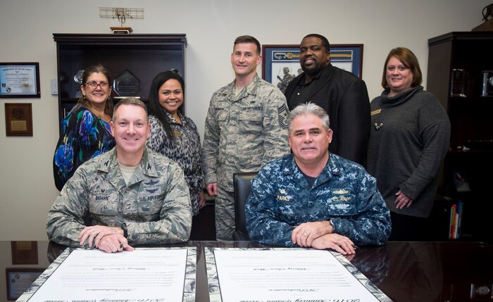 Col. Robert Lyman, Joint Base Charleston commander, Chief Master Sgt. Mark Bronson, 628th Air Base Wing command chief, and Capt. Timothy Sparks, JB Charleston deputy commander, take a group photo with Military Saves Campaign members Jan. 25, 2016, at the headquarters building on Joint Base Charleston – Air Base, S.C. Military Saves is a campaign that helps servicemembers and their families save money and reduce debt. (U.S. Air Force photo/Senior Airman Clayton Cupit)
