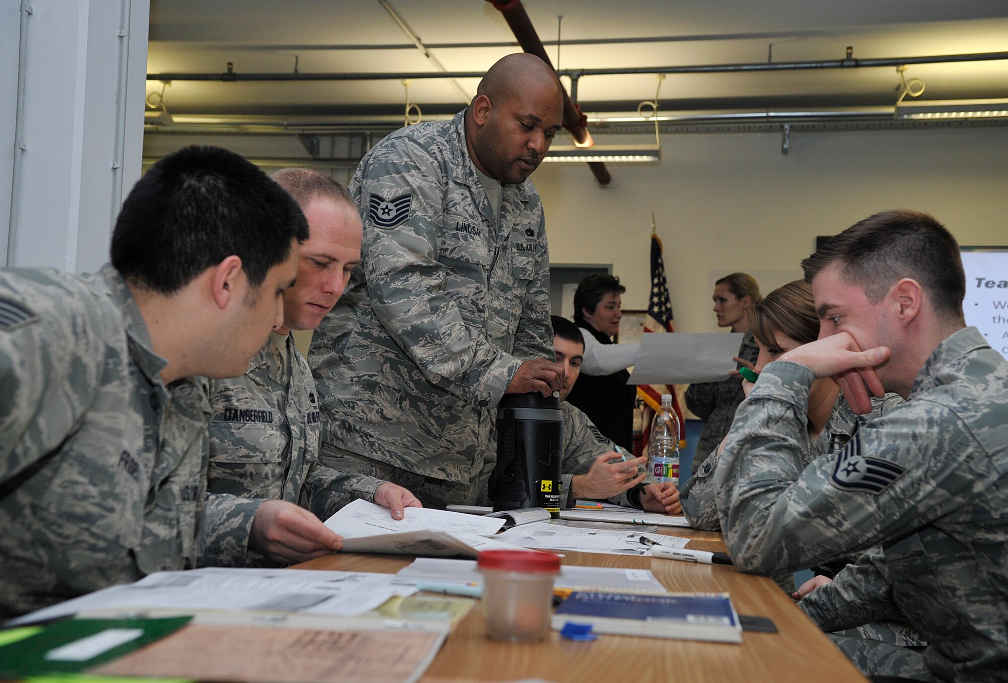 A team of Airmen work together during a Problem Identification Training scenario Jan. 12, 2016, at Ramstein Air Base, Germany. Teams began with a simulated problem and learned how to fix it in a more efficient and effective manner. These tools can help them innovate new ways of improving processes already in place in their units. In March, Innovation Madness recognizes those Airmen with innovations and ideas improving their units and the Air Force as a whole.   (U.S. Air Force photo/Airman 1st Class Larissa Greatwood)