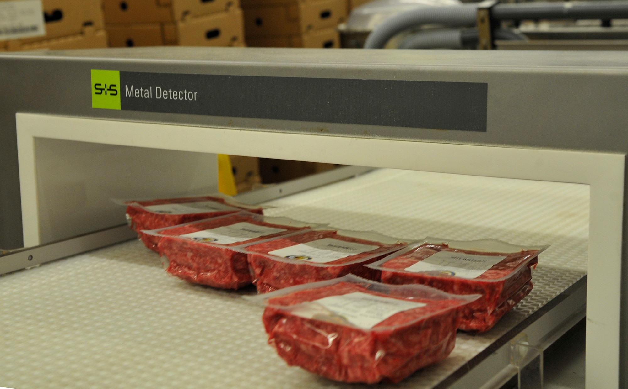 Packages of ground beef go through a metal detector at the Ramstein Central Meat Processing Plant Jan. 25, 2016, at Ramstein Air Base, Germany. All meat processed by the Ramstein CMPP goes through a metal detector to ensure safe consumption. Employees test the machines every hour to confirm their accuracy. (U.S. Air Force photo/Airman 1st Class Larissa Greatwood)