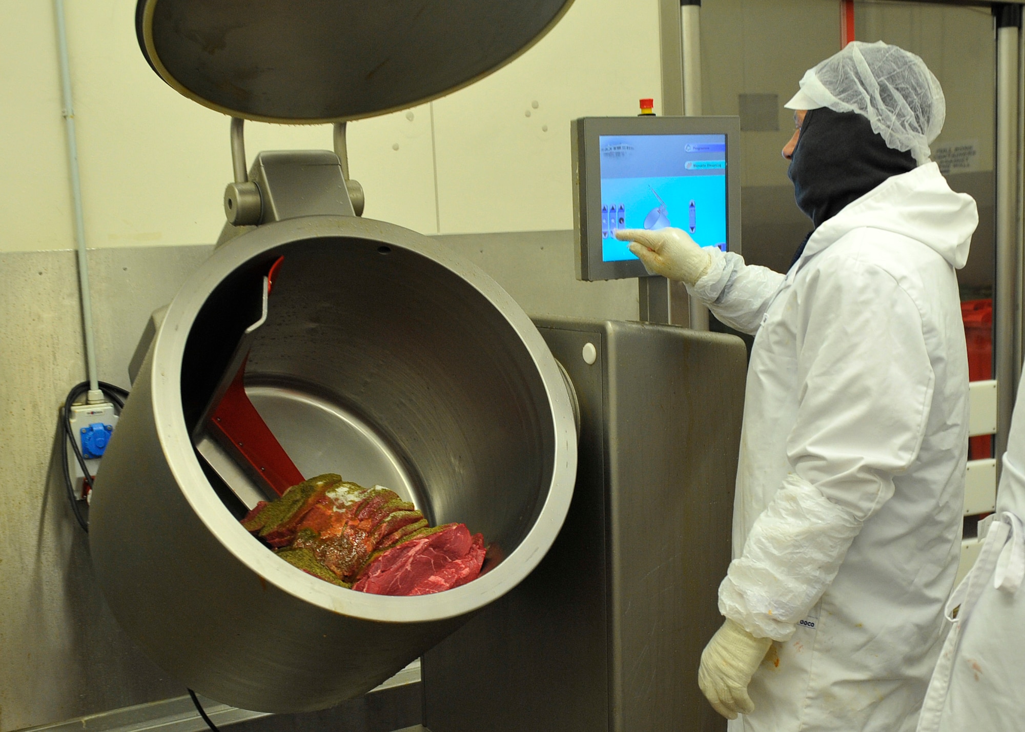 Sven Fischer, Defense Commissary Agency employee, adds spices and oil to beef before packaging at the Ramstein Central Meat Processing Plant Jan. 25, 2016, at Ramstein Air Base, Germany. The Ramstein CMPP tests different spice recipes and sells them to customers for convenience and variety. (U.S. Air Force photo/Airman 1st Class Larissa Greatwood)