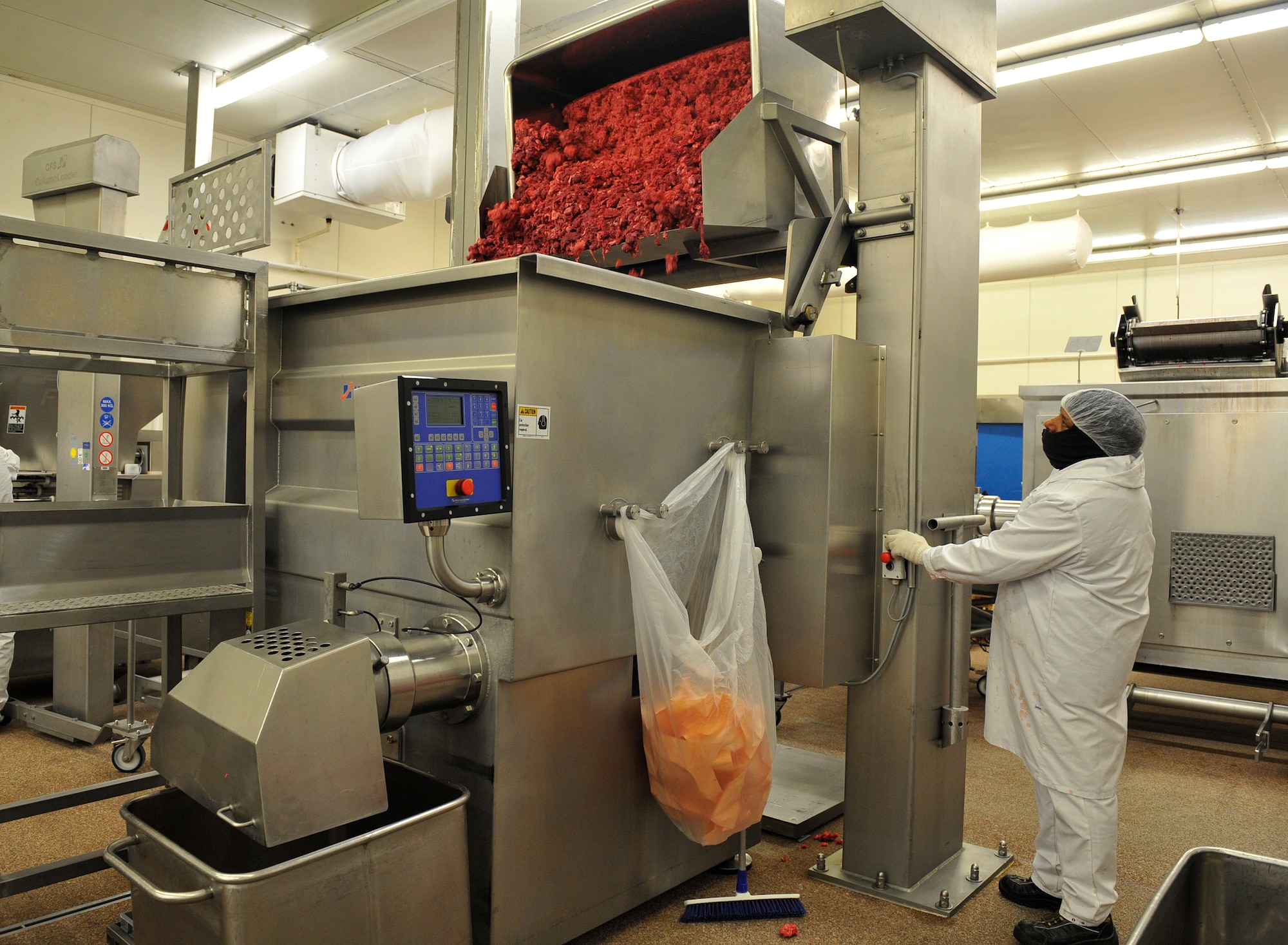 Dennis Wilson, Defense Commissary Agency employee, grinds beef at the Ramstein Central Meat Processing Plant Jan. 25, 2016, at Ramstein Air Base, Germany. The Ramstein CMPP is the sole source of fresh beef and pork for all European commissaries throughout 11 NATO countries. (U.S. Air Force photo/Airman 1st Class Larissa Greatwood)