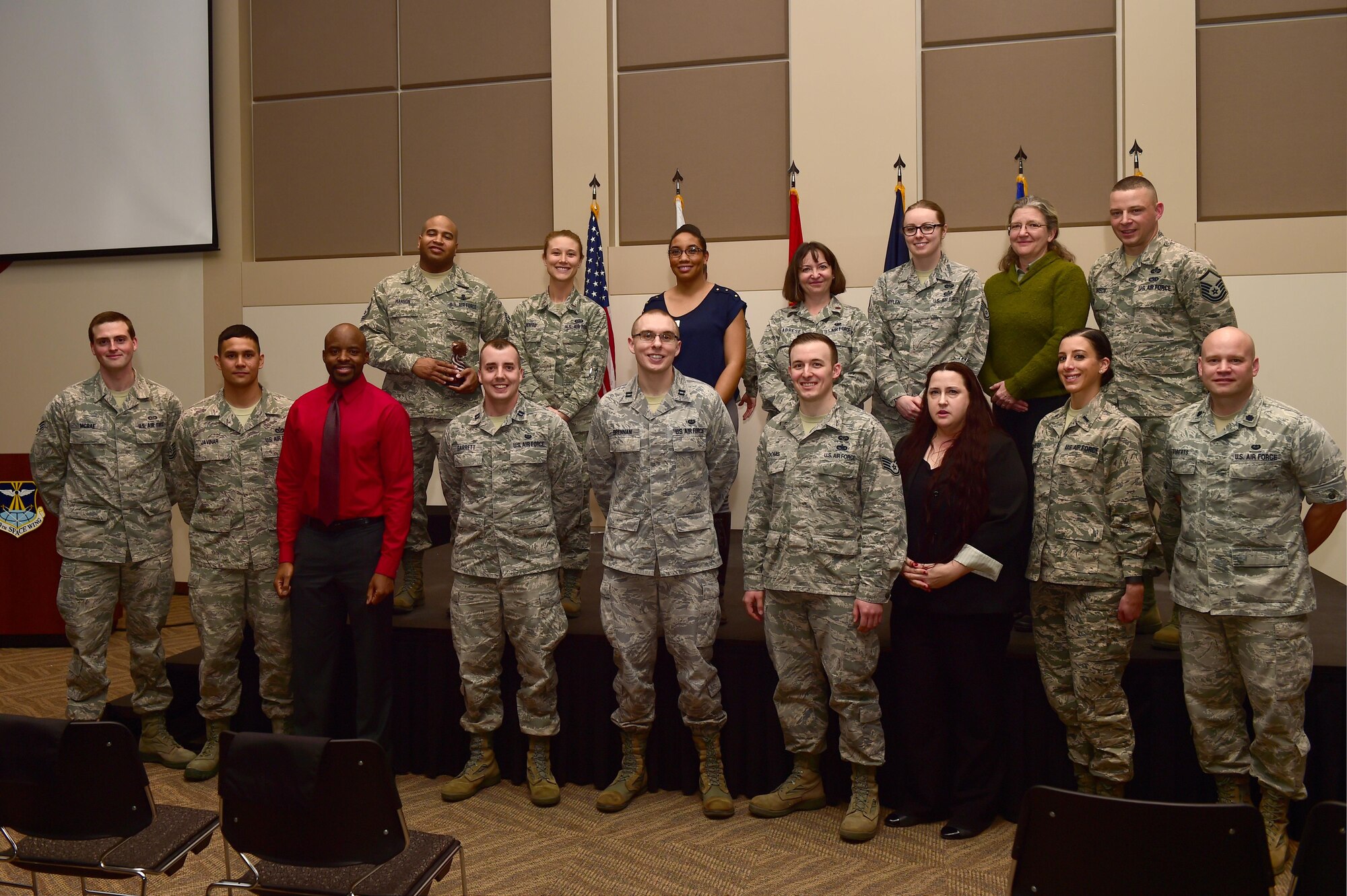The 460th Space Wing quarterly award winners stand together Jan. 28, 2016, at the Leadership Development Center on Buckley Air Force Base, Colo. The award winners were chosen because of their hard work and dedication in their work centers. (U.S. Air Force photo by Airman 1st Class Gabrielle Spradling/Released)