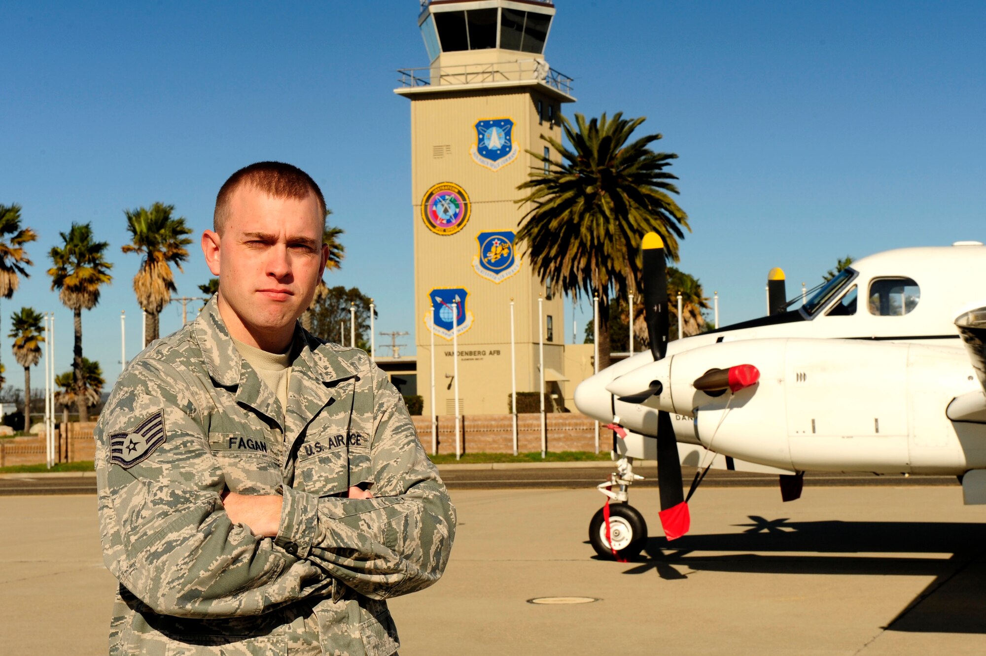 Staff Sgt. Blake Fagan, 30th Operations Support Squadron NCO in charge of airfield management, poses on the runway, Jan. 26, 2016, at Vandenberg Air Force Base, Calif. Fagan oversees the customer service section which deals with all aircraft support, airfield maintenance and any safety requirements on the airfield. (U.S. Air Force photo by Staff Sgt. Jim Araos/Released)