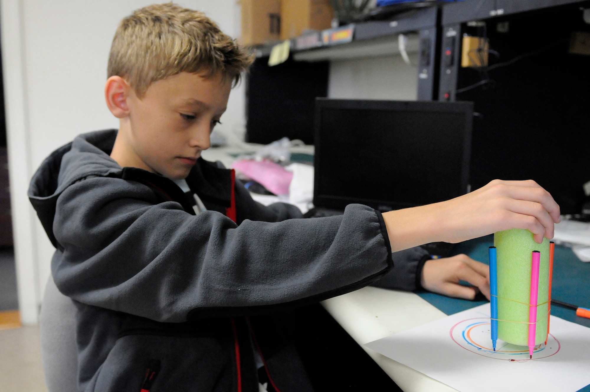 Landon Henry, son of Master Sgt. Brian Henry of the Kentucky Air National Guard’s 123rd Airlift Wing, assembles a doodle bot that he created at the Air Force Services Activity Technology Camp in San Antonio, Texas, in August 2015. Henry was selected from among dependent applicants across the Air Force to attend the camp, which focuses on building confidence with technology through problem solving and hands-on learning. (U.S. Air National Guard photo by Tech. Sgt. Vicky Spesard)