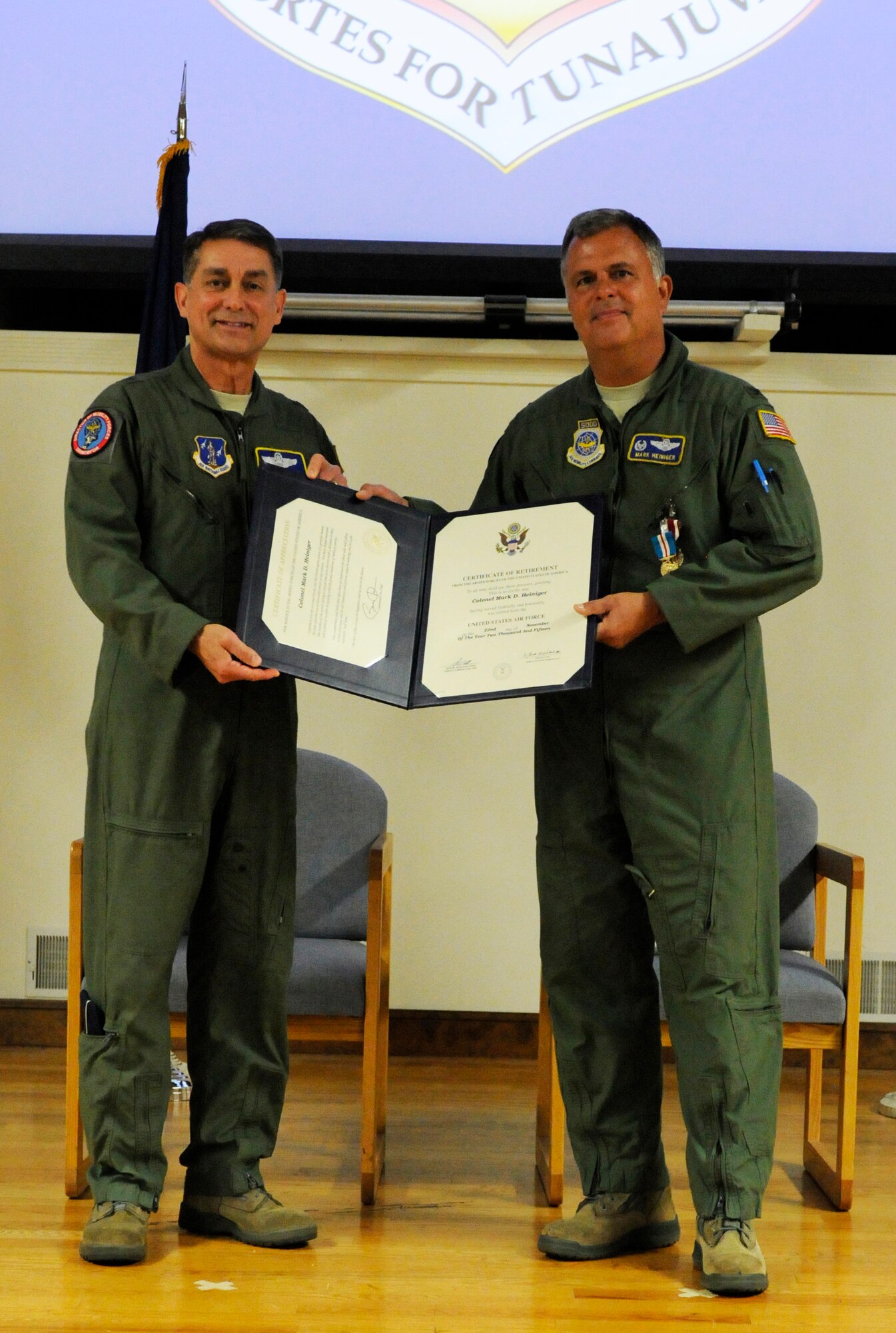Brig. Gen. Warren H. Hurst, Kentucky's assistant adjutant general for Air, presents the certificate of retirement to Col. Mark Heiniger who officially retired from service during a ceremony held at the 123rd Airlift Wing, Louisville, Kentucky, Nov. 07, 2015. He retires with more than 28 years of service most recently as the State Operations Officer for Joint Force Headquarters Kentucky. (U.S.Air National Guard photo by Tech. Sgt. Vicky Spesard)