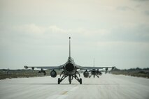 A U.S. Air Force pilot from the 480th Expeditionary Fighter Squadron taxis an F-16 Fighting Falcon fighter aircraft during a flying training deployment on the flightline at Souda Bay, Greece, Jan. 27, 2016. The training took place on the northwest bay of Crete, alongside the island's White Mountain range and over the Mediterranean Sea. (U.S. Air Force photo by Staff Sgt. Christopher Ruano/Released)