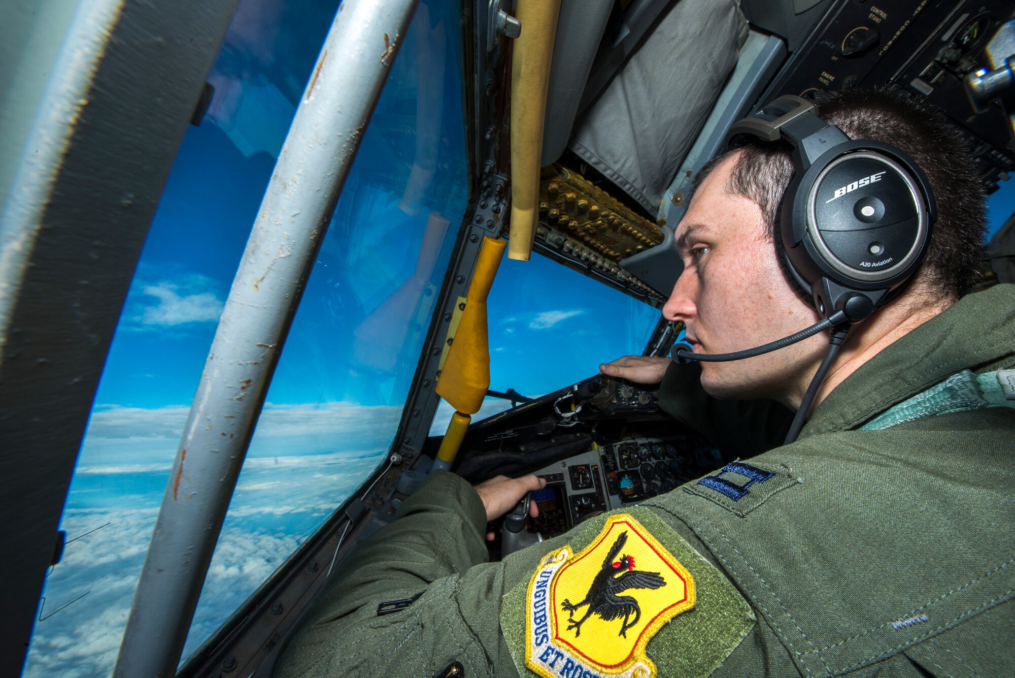 U.S. Air Force Capt. Christopher Thompson, 909th Air Refueling Squadron KC-135 Stratotanker pilot, scans the horizon for other aircraft during Forceful Tiger Jan. 28, 2016, near Okinawa, Japan. The 909th ARS, which is charged with supplying fuel to other aircraft in flight, delivered a total of 1.3 million pounds of fuel to more than 130 aircraft during the large force exercise. (U.S. Air Force photo by Staff Sgt. Maeson L. Elleman)