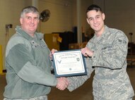Airman 1st Class Michael Stainbrook, 22nd Logistics Readiness Squadron vehicle operator/dispatcher, poses with Col. Albert Miller, 22nd Air Refueling Wing commander, Jan. 25, 2016, at McConnell Air Force Base, Kan. Stainbrook received the spotlight performer for the week of Jan. 25–29 for his exceptional skills and work ethic as well as helping an Airman who was robbed and couldn’t gain access to base. (U.S. Air Force photo/Senior Airman David Bernal Del Agua)