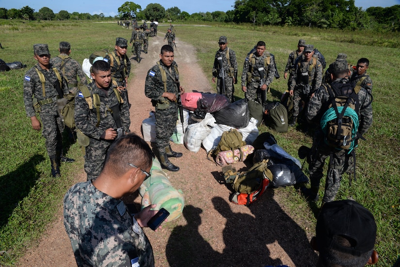 Honduran troops wait to load on to a U.S. Army UH-60 Blackhawk helicopter, in the Gracias a Dios Department (state), Honduras, Jan. 14, 2016. The troops rotate through various operating locations within the department to help counter drug trafficking with the support of the U.S. helicopters for part of the transportation required to reach the outlying locations. (U.S. Air Force photo by Senior Airman Westin Warburton/Released)