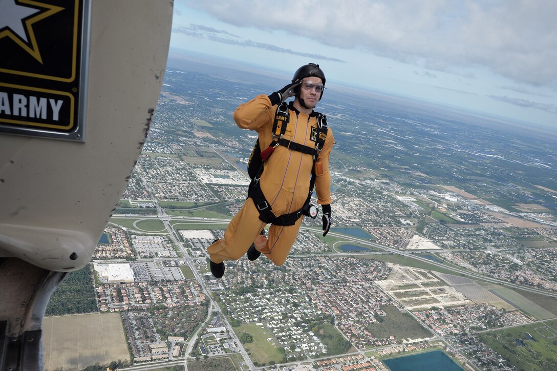 A member of the Golden Knights, the Army's demonstration team, salutes as he exits a Fokker C-31A troopship during a training jump over Homestead Air Reserve Base, Fla., Jan. 21, 2016. New York Air National Guard photo by Staff Sgt. Christopher S. Muncy