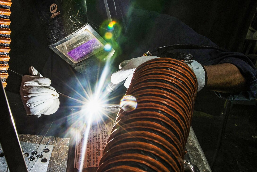 Navy Seaman Tyler Butler welds equipment on the USS Dwight D. Eisenhower in the Atlantic Ocean, Jan. 28, 2016. The aircraft carrier is preparing for an inspection and conducting carrier qualifications. Navy photo by Petty Officer 3rd Class Ryan U. Kledzik