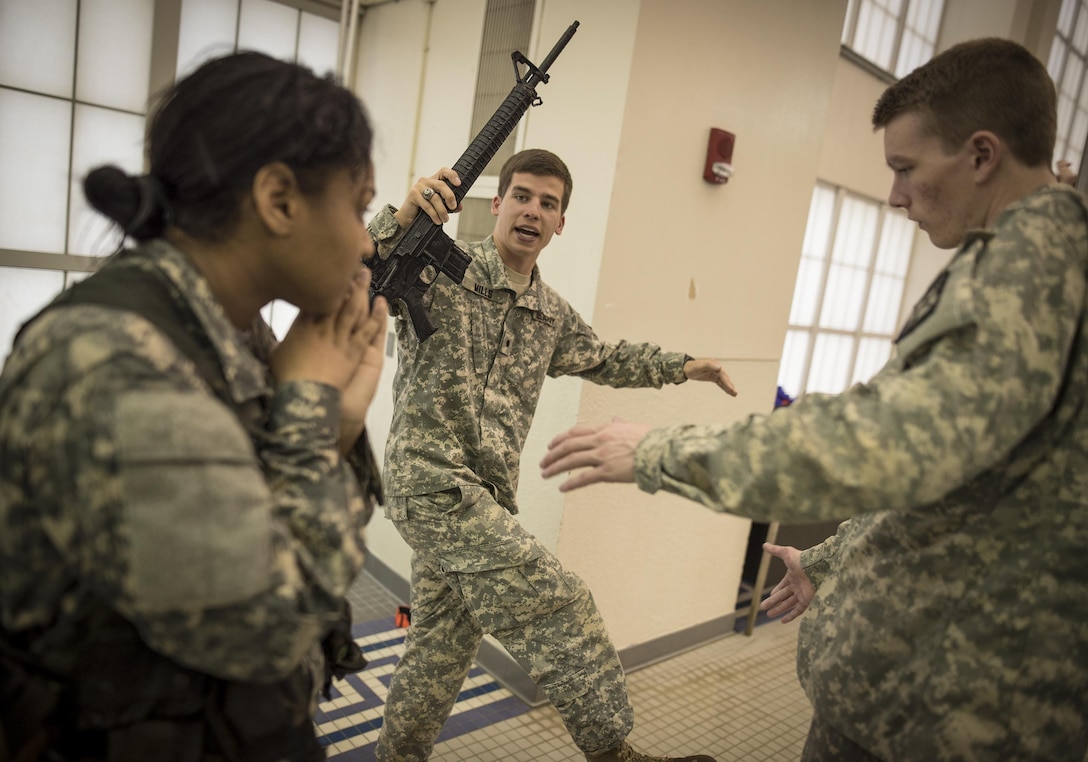 U.S. Army Reserve Officers' Training Corps cadet Preksha Jayamarughyraman (left), 20, a Clemson University sophomore from Alexandria, Va., studying biolgogical science, gets briefed by senior cadets before performing the 15-meter swim portion of the Combat Water Survival Test, Jan. 28, 2016. (U.S. Army photo by Staff Sgt. Ken Scar)