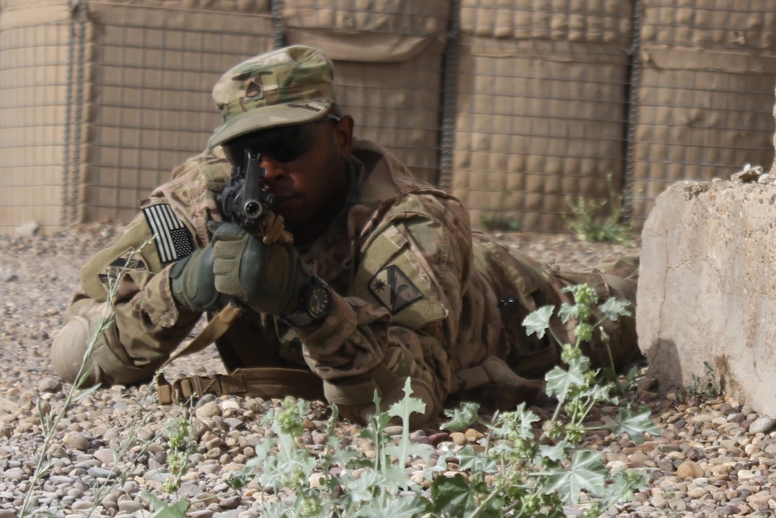 U.S. Army Staff Sgt. Mitchell Tull II provides security while practicing reaction to contact as part of unit battle drill training exercises in Iraq, April 10, 2015. Tull is a communications and electronics specialist with the 82nd Sustainment Brigade attached to the 310th Forward Advise and Assist Team. Their mission is to advise and assist the Iraqi armed forces with logistics operations. Army photo by Capt. Adrian S. Taylor