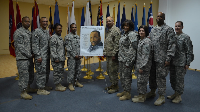 Army Maj. Henry McCaskill, Jr. (center), the operations chaplain (forward) for the 1st Theater Sustainment Command, stands with soldiers from the equal opportunity sections from the 143d Sustainment Command and the 1st TSC. The 143d ESC invited McCaskill—currently deployed to Afghanistan—to attend the Dr. Martin Luther King, Jr. celebration held Jan. 20 at Camp Arifjan, Kuwait, to speak to service members, contractors and Department of Defense civilians about his experiences growing up in Alabama during the 1960s. McCaskill's father, Henry McCaskill, Sr., helped organize many of the rallies, marches and meetings associated with King's civil rights movement.
