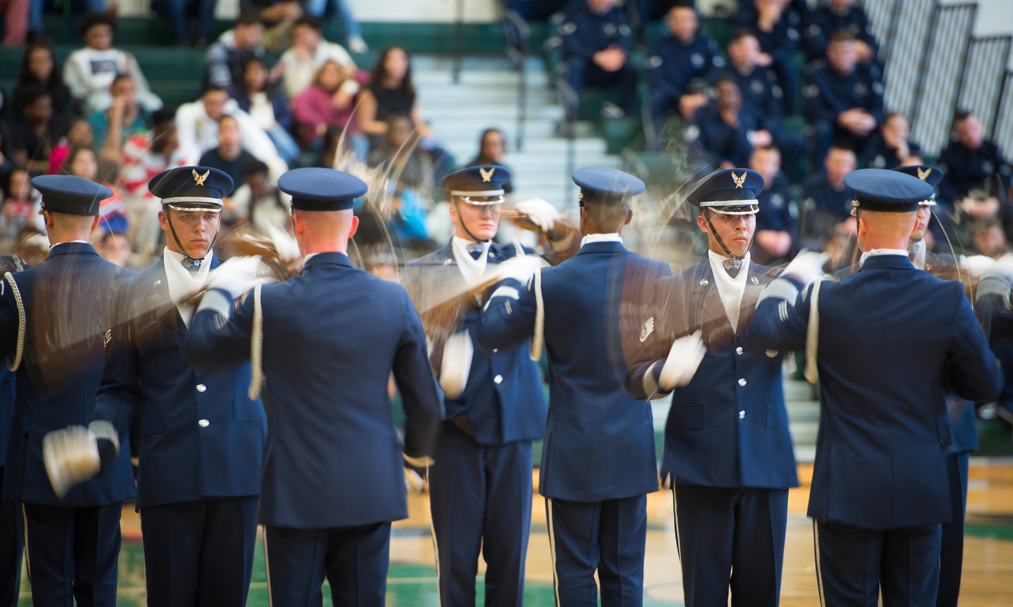 Members of the United States Air Force Honor Guard drill team spin their M1 Garand rifles at Oak Ridge High School, Orlando, Fla. Jan. 21, 2016. The Drill Team performed in front of hundreds of students and afterward held a training session with the Junior Reserve Officer Training Corps cadets. (U.S. Air Force photo by Staff Sgt. Chad C. Strohmeyer/Released)