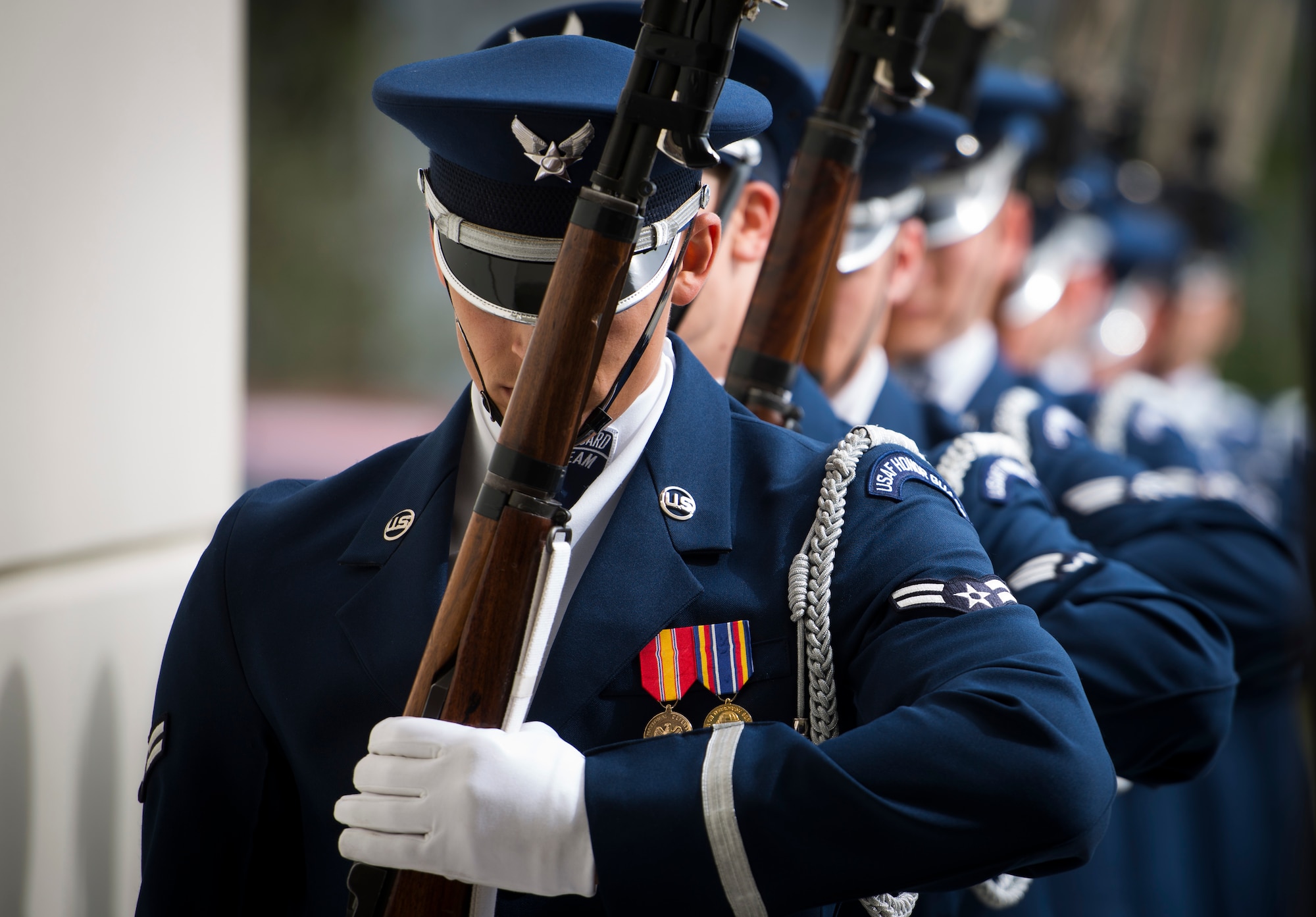 Members of the United States Air Force Honor Guard drill team march in to the gymnasium at Oak Ridge High School, Orlando, Fla. Jan. 21, 2016. The Drill Team performed in front of hundreds of students and afterward held a training session with the Junior Reserve Officer Training Corps cadets. (U.S. Air Force photo by Staff Sgt. Chad C. Strohmeyer/Released)