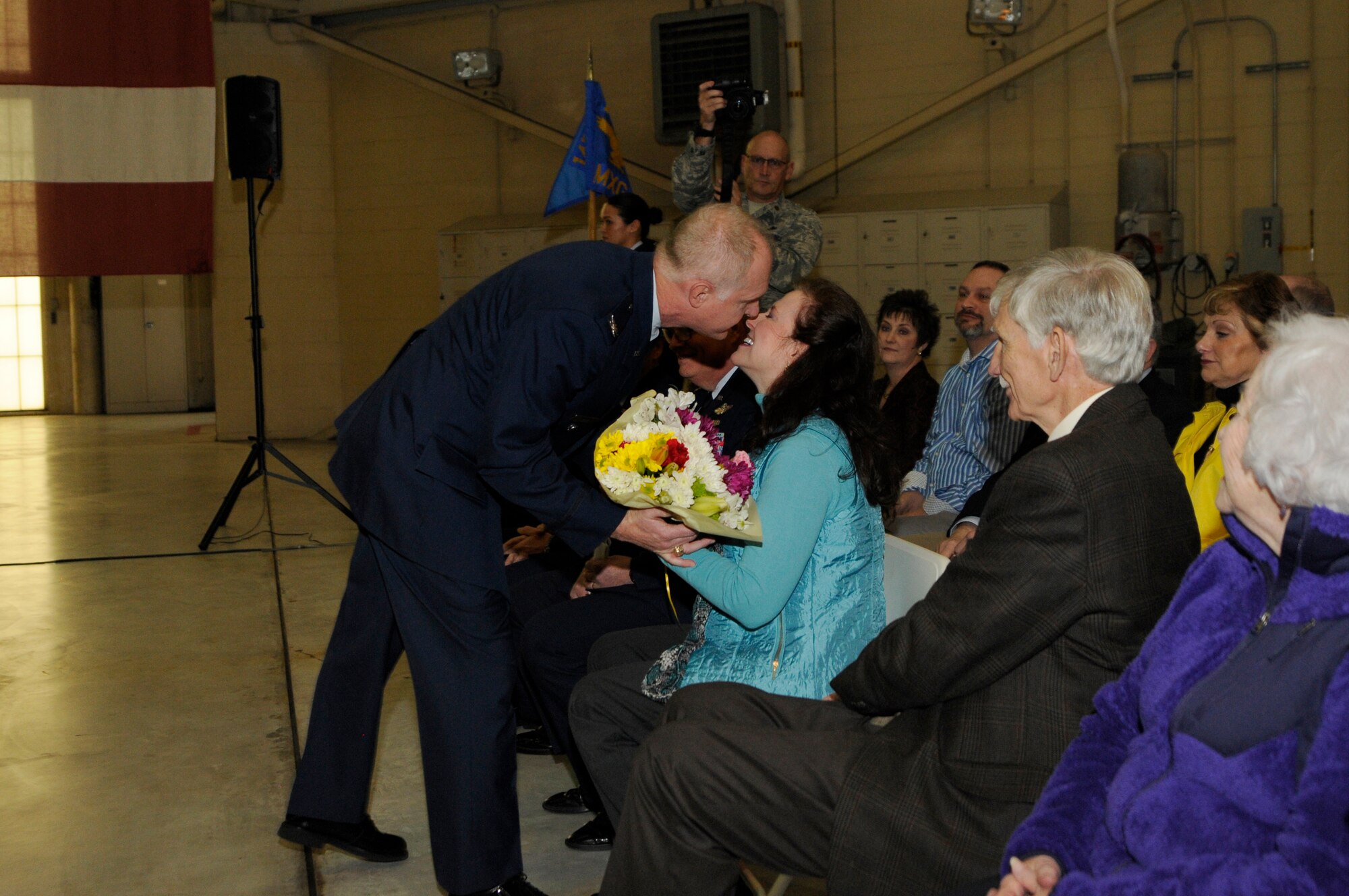 U.S. Air Force Col. Allan R. Cecil, commander, 145th Maintenance Group, presents a bouquet of flowers to his spouse during his Change of Command and promotion ceremony held at the North Carolina Air National Guard Base, Charlotte Douglas International Airport, Jan. 9, 2016. During his speech Cecil thanked his mentors and his spouse for their guidance throughout his career. (U.S. Air National Guard photo by Staff Sgt. Julianne M. Showalter /Released)