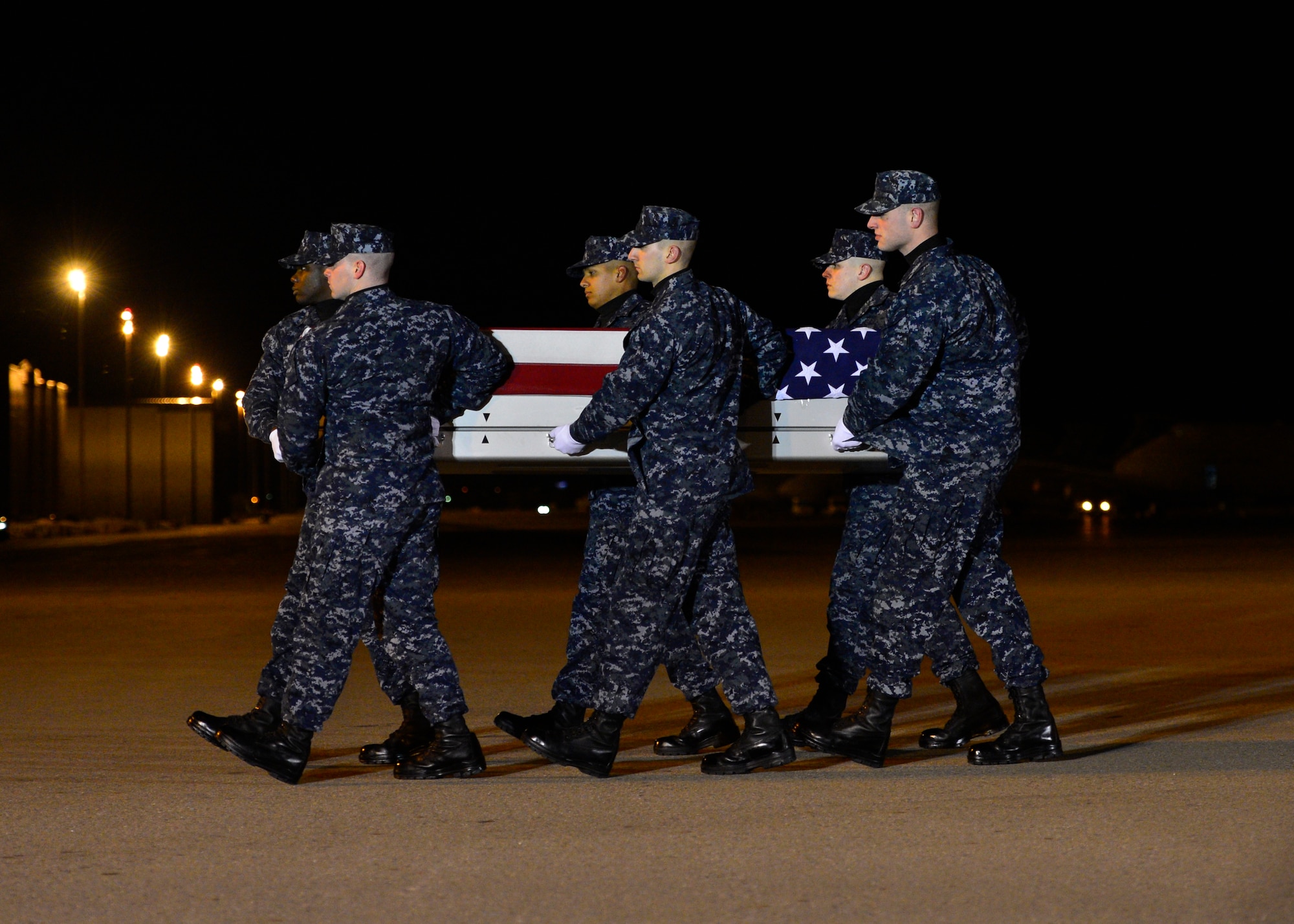 A U.S. Navy carry team transfers the remains of U.S. Navy civilian Blane D. Bussell, a native of Virginia, during a dignified transfer Jan. 29, 2016, at Dover Air Force Base, Del. Mr. Bussell was assigned to Naval Support Activity, Bahrain. (U.S. Air Force photo/Senior Airman Zachary Cacicia)